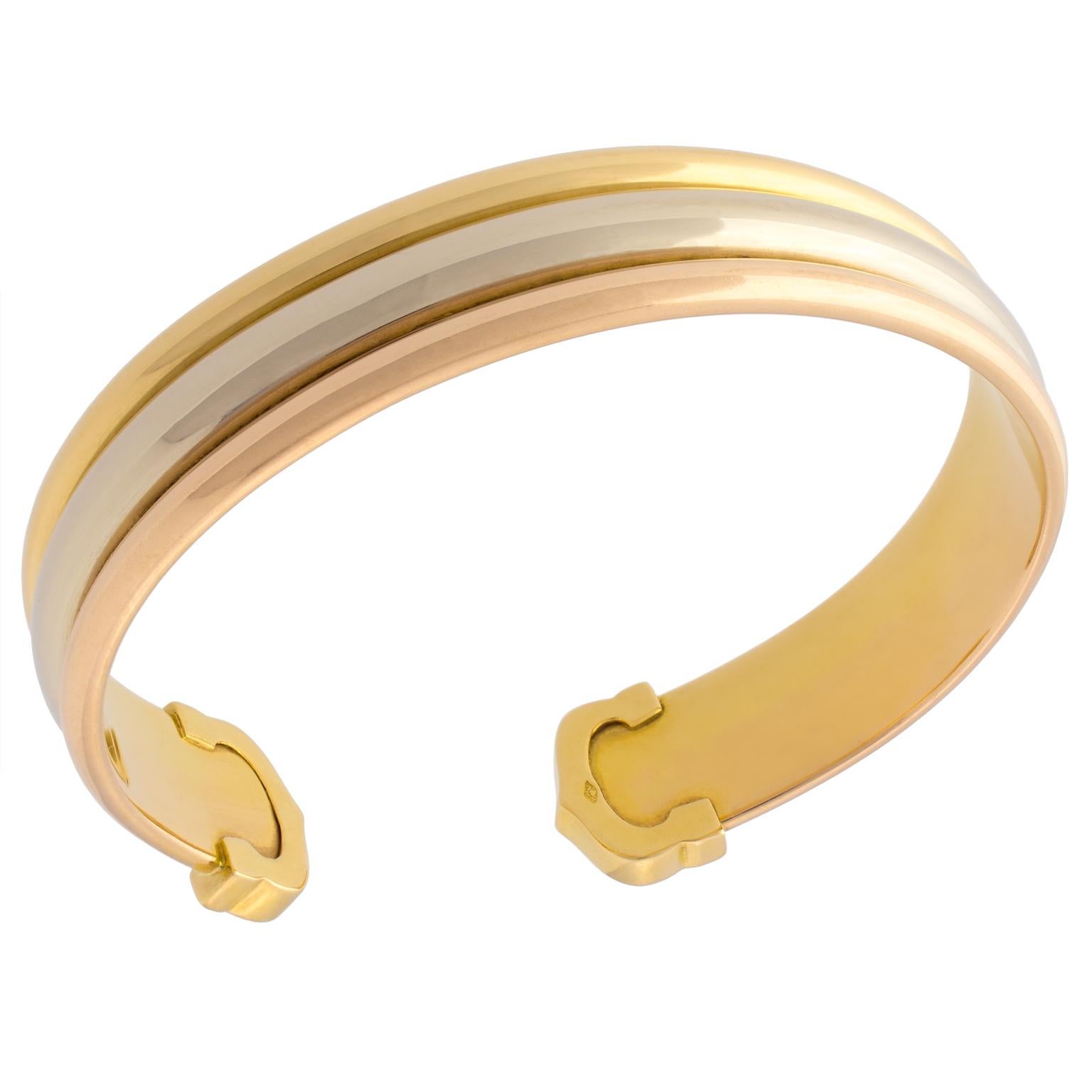 Cartier Trinity Trigold Double C cuff bracelet in white, yellow and rose gold.
Size 17