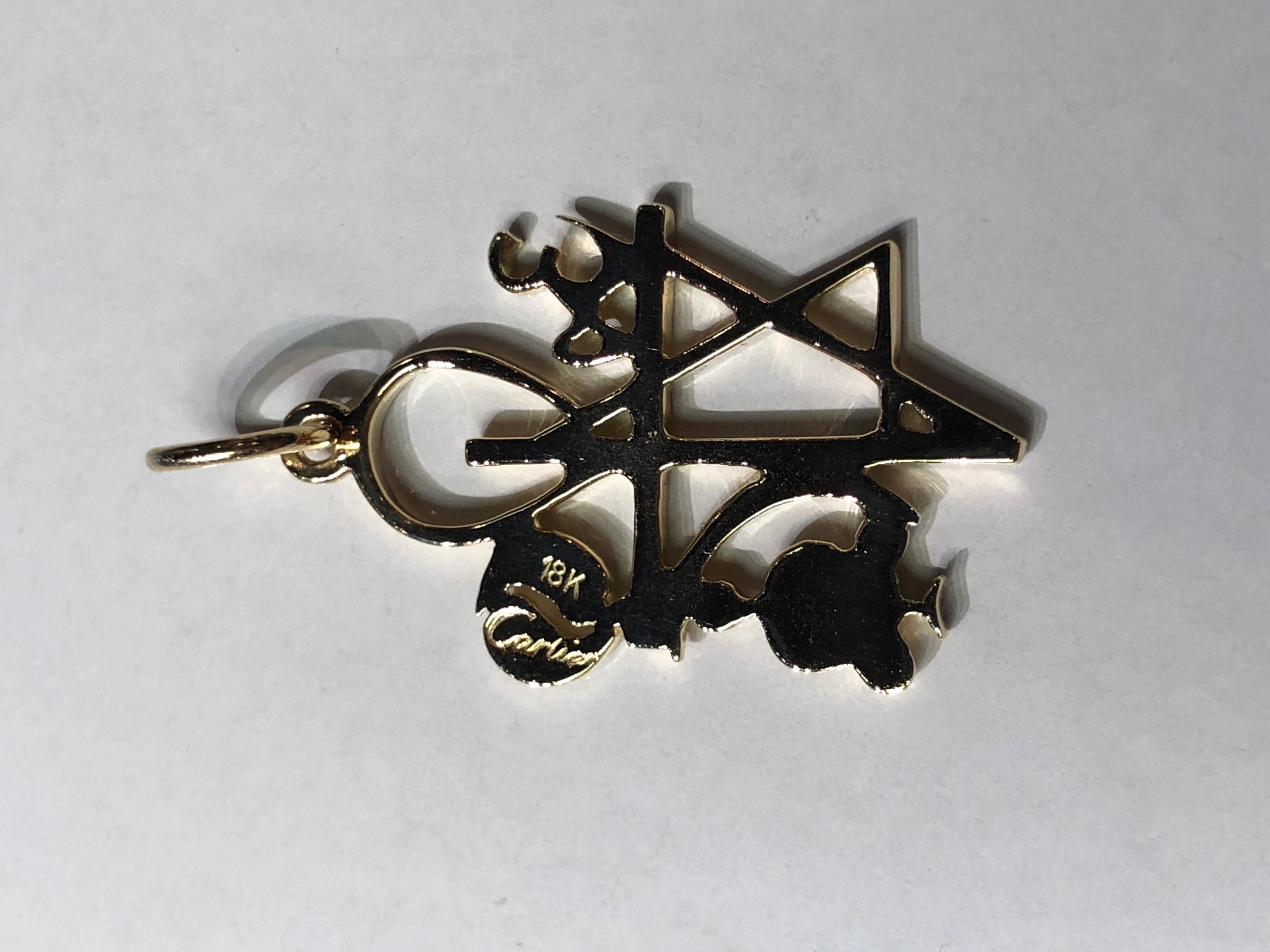 A unique abstract figural pendant/charm that represents the unity of all religions.  Made and signed by CARTIER.  18K shiny and matte finish yellow gold.  1 1/4
