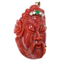 Gold carved oxblood coral diamond and emerald pendant brooch