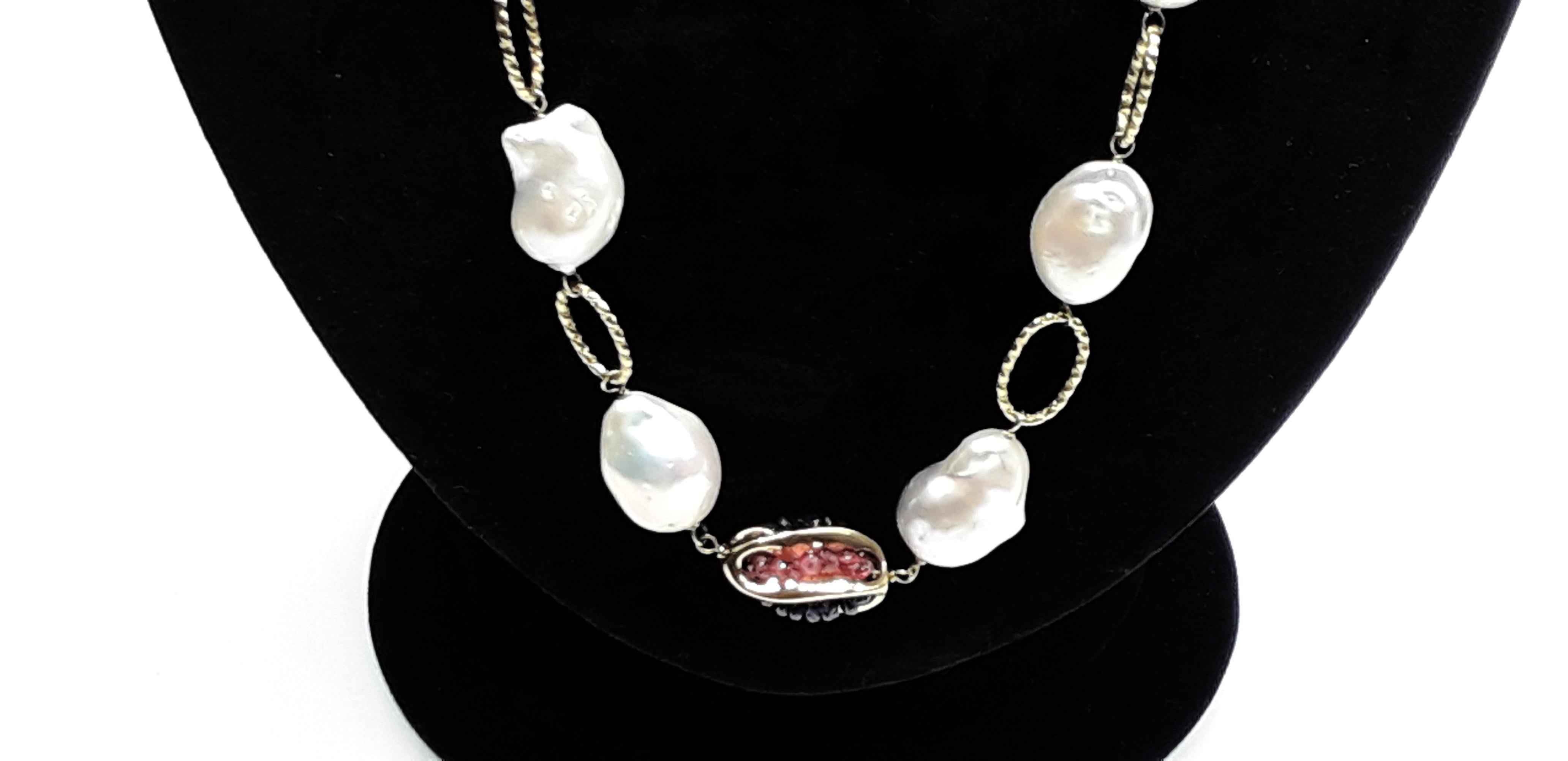 Refined necklace with 18K Gold chain. The necklace is characterized by river pearls alternated with red rubies and blue sapphires. High Italian gold craftsmanship. An ideal necklace for an summer evening.
