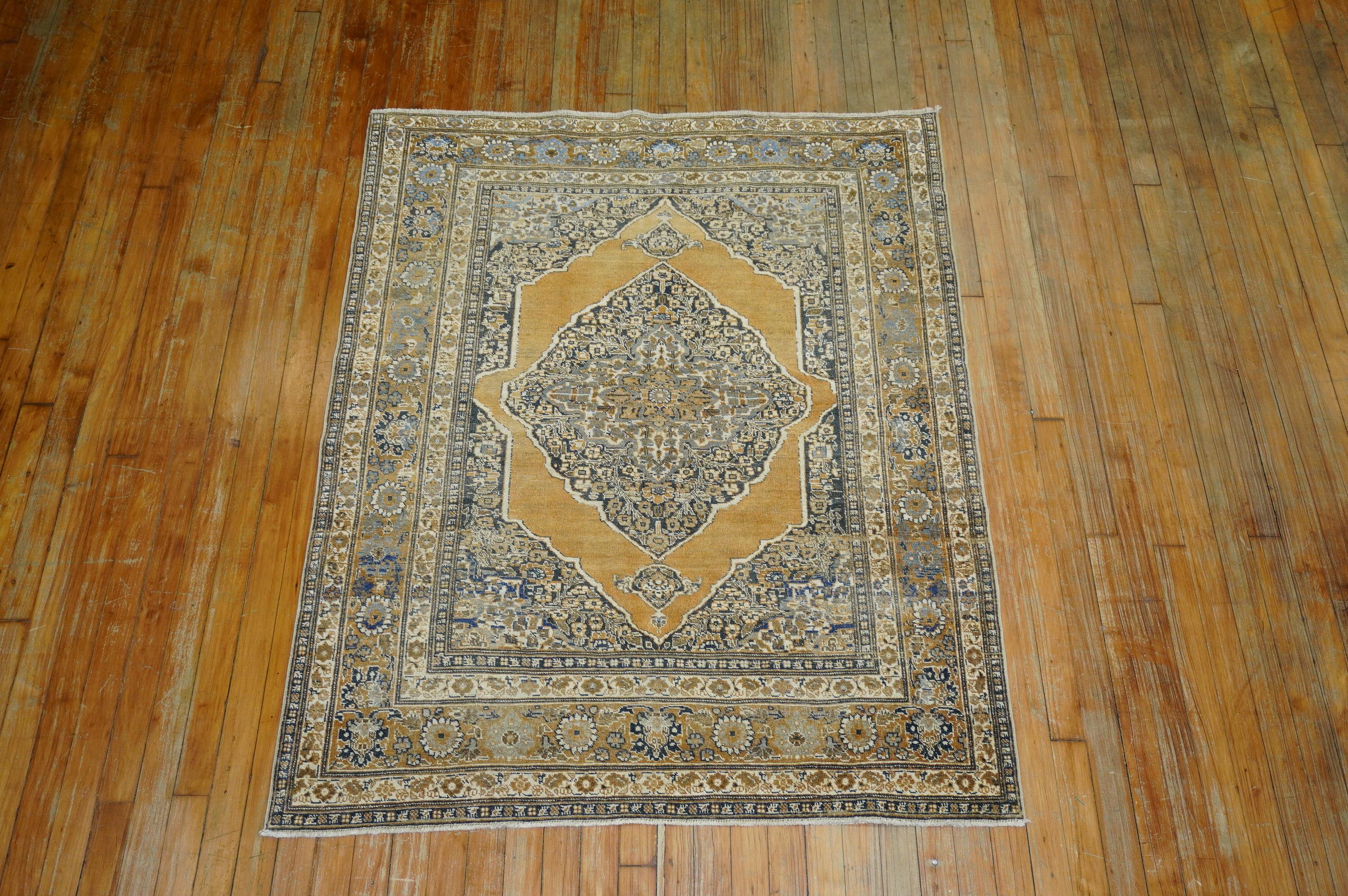 An early 20th century Persian gold charcoal color base Classic Medallion and Border Design Tabriz rug, circa 1910.

Measures: 3'11” x 5'.