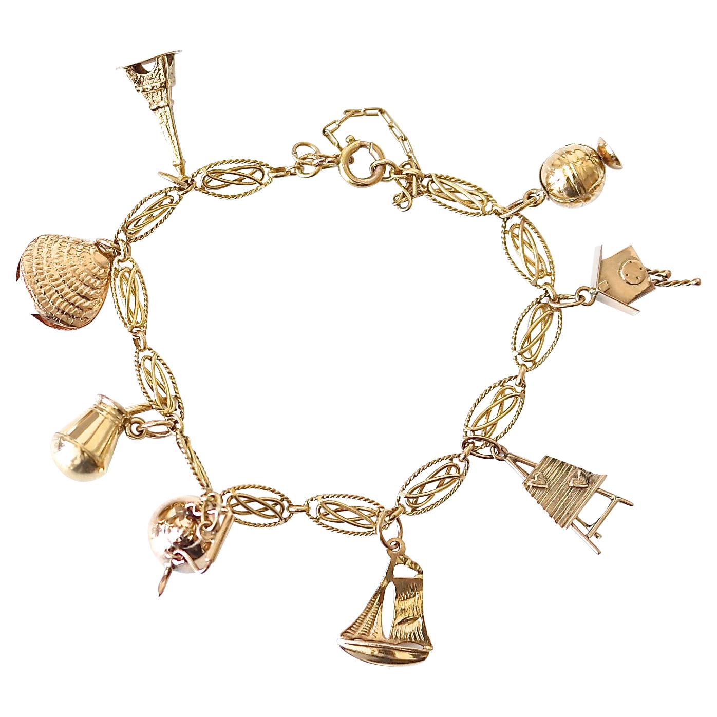 Traditional 1950s and 1960s Gold Charm Bracelet with Enamel and Mechanical  Charms