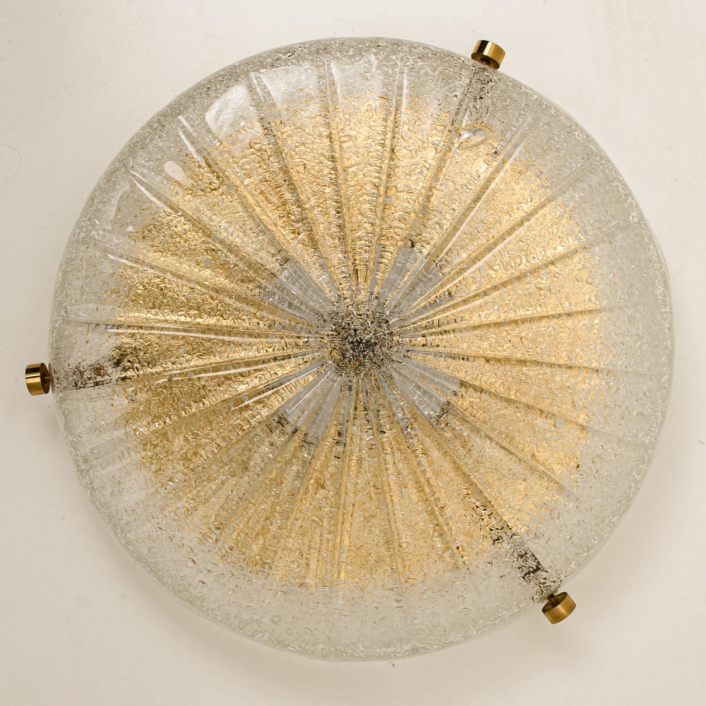 Stunning high-end brass and Murano glass flush mount manufactured in the late 1960s-early 1970s.  The think glass has a beautiful textured structure. With stripes of clear and opaque glass. Beautiful craftsmanship of the 20th century.

The timeless