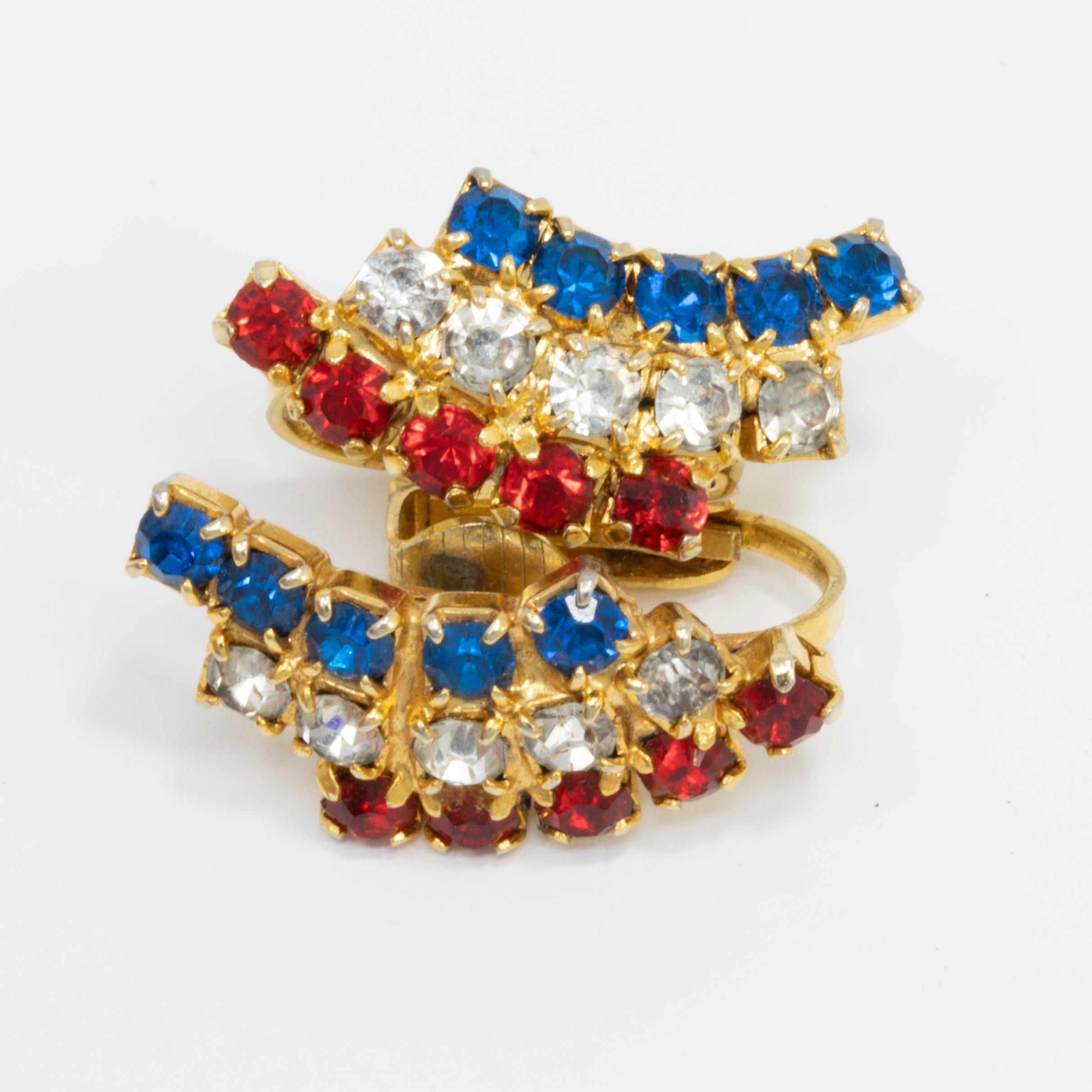 A pair of golden clip on earrings, featuring motifs with red, white, and blue crystals. A classy touch of vintage fashion!

Gold-plated. Circa late 1900s.
