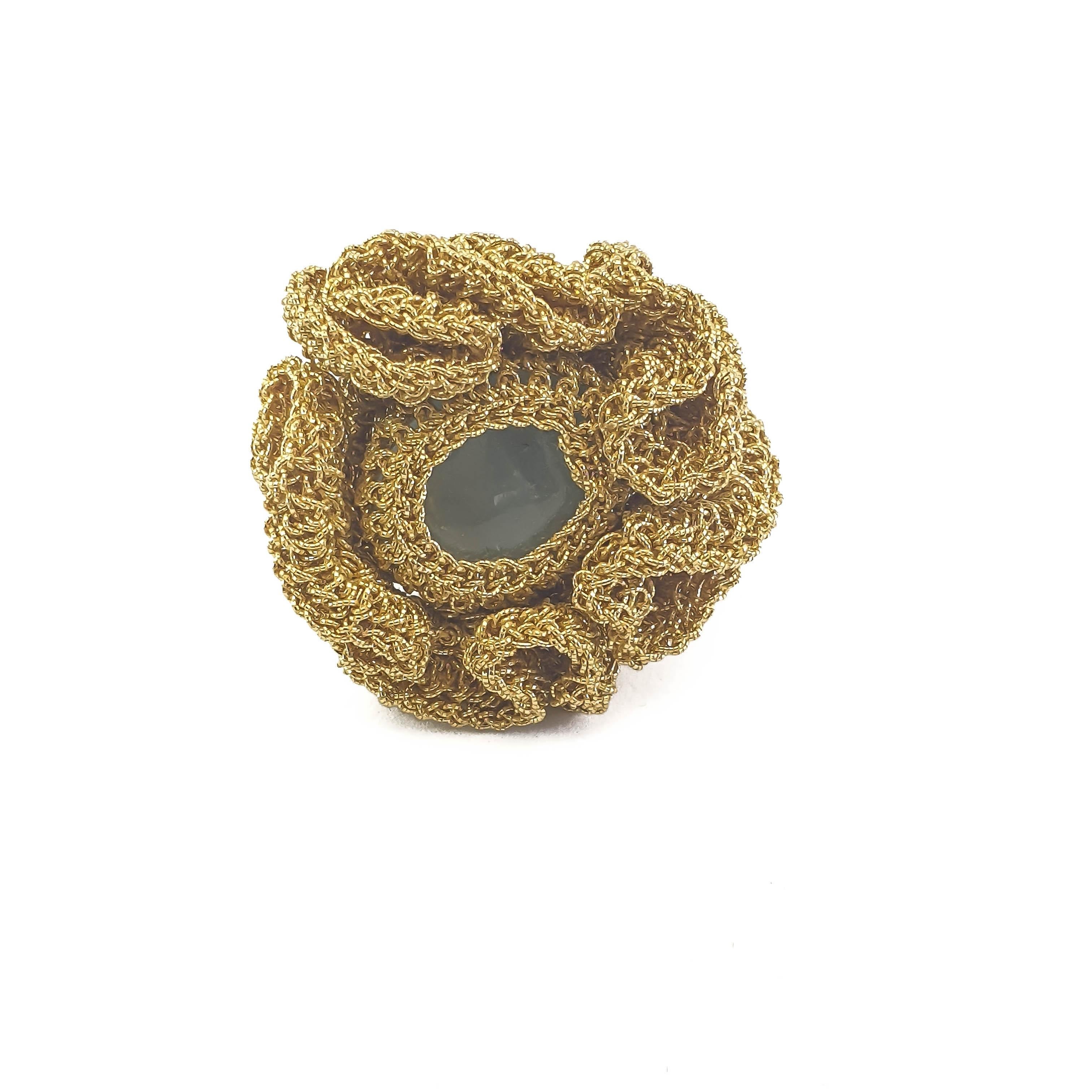 A beautifully crafted, crochet ring. Handmade with 18 Karat gold thread (13.25 grams) and a milky light blue Aquamarine (weighing 1.75 grams/8.75 carats). This ring is a US size 7. It can be stretched a little to fit larger sizes. This ring can be
