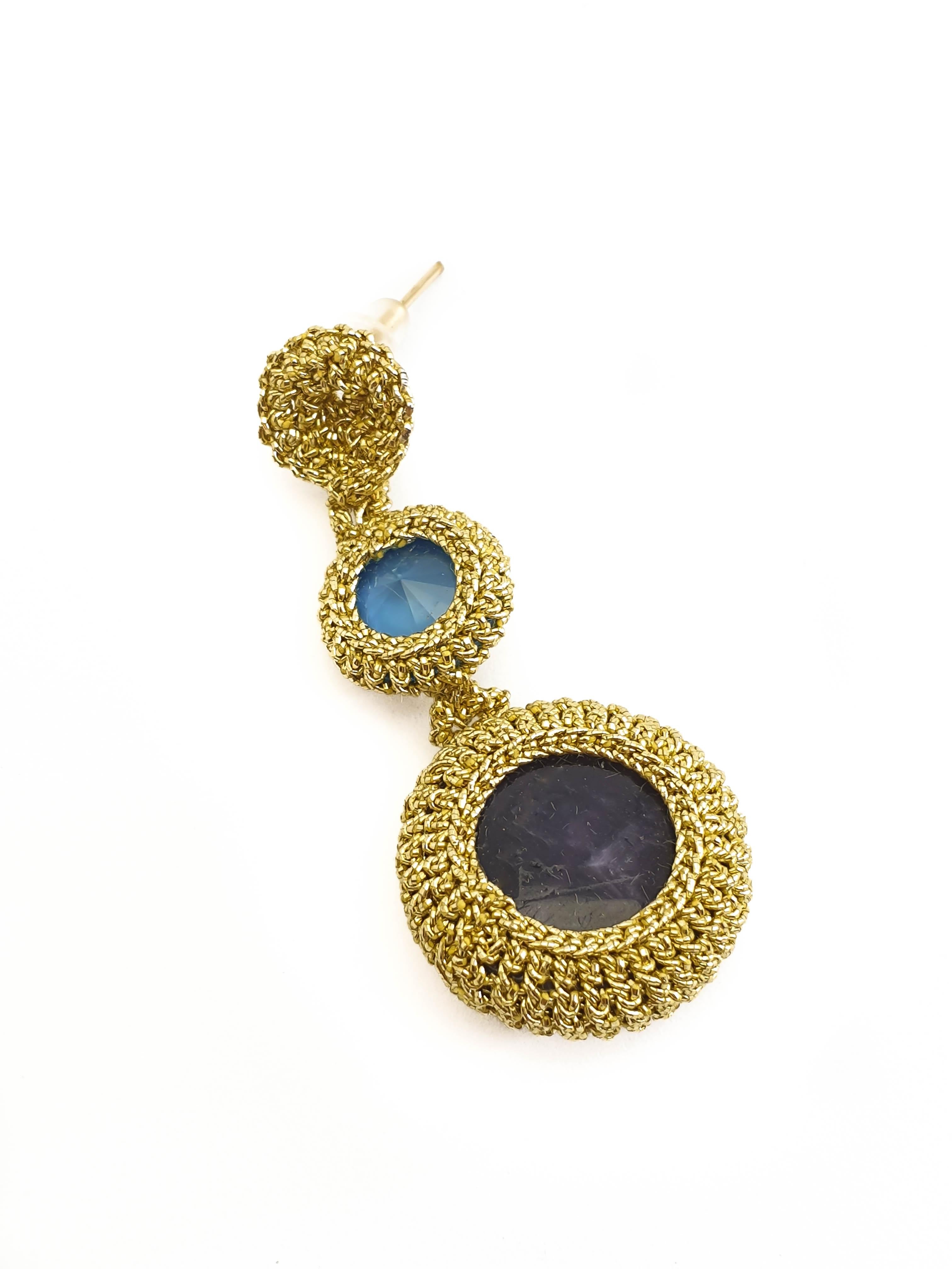 Fashionable, eye catching crochet earrings. Gold color thread tightly crochet around Natural Amethysts and vintage blue Swarovski  crystals.
These earrings can be custom made. Choice of stones can be altered.

The earrings are crochet with a smooth