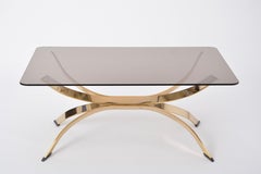 Gold Colored Mid-Century Modern coffee table with smoked Glass top