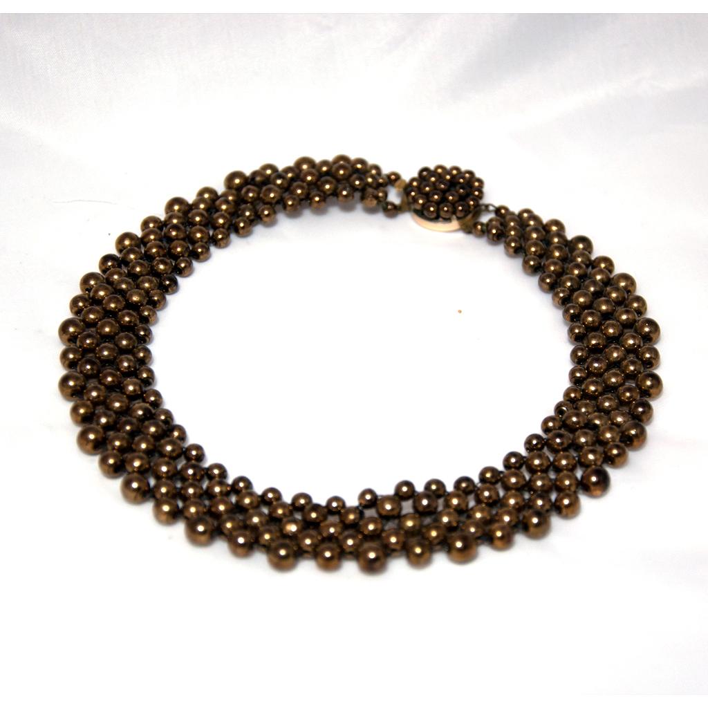 Gold-coloured to bronze-coloured necklace, Choker, 1950s
tight-fitting necklace made of four rows of bronze coloured glass beads, the beads are woven together so that the necklace flatters the wearer around the neck. The effect is more like that of