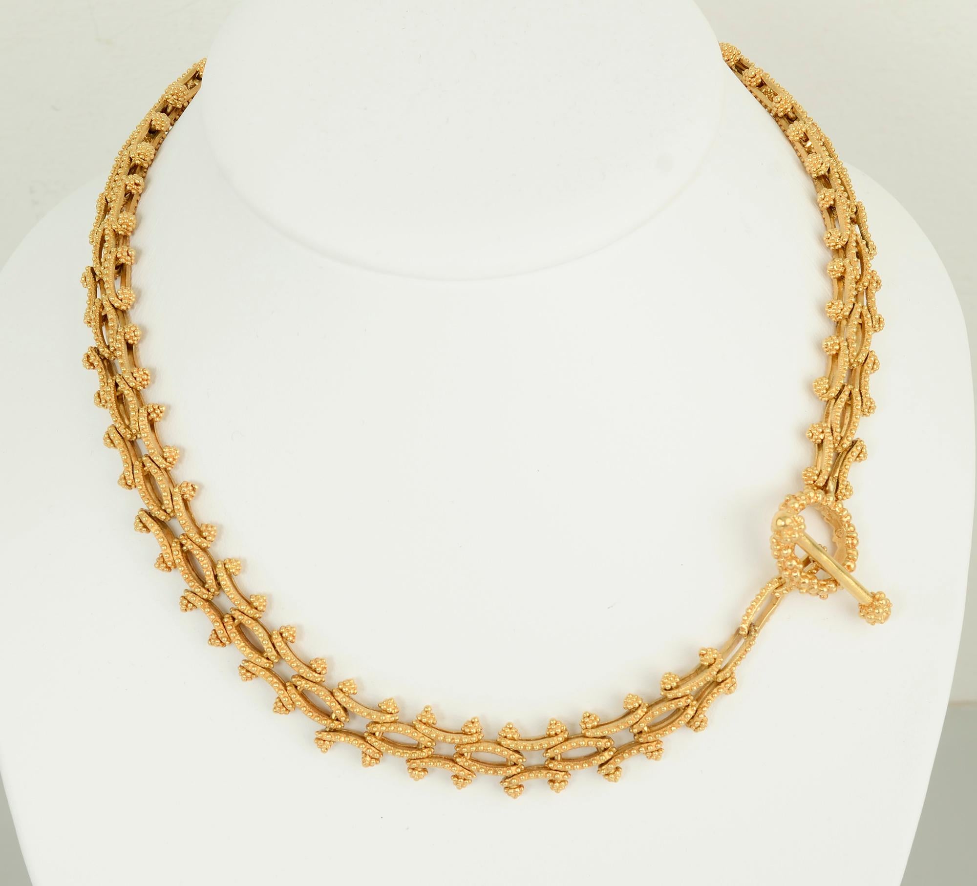 This unusual gold link necklace and bracelet combination is elegant and versatile. It can be worn as an 18 inch necklace and 7 3/4 inch bracelet or combined to create a long necklace.
The links are both concave and convex. They are all covered with