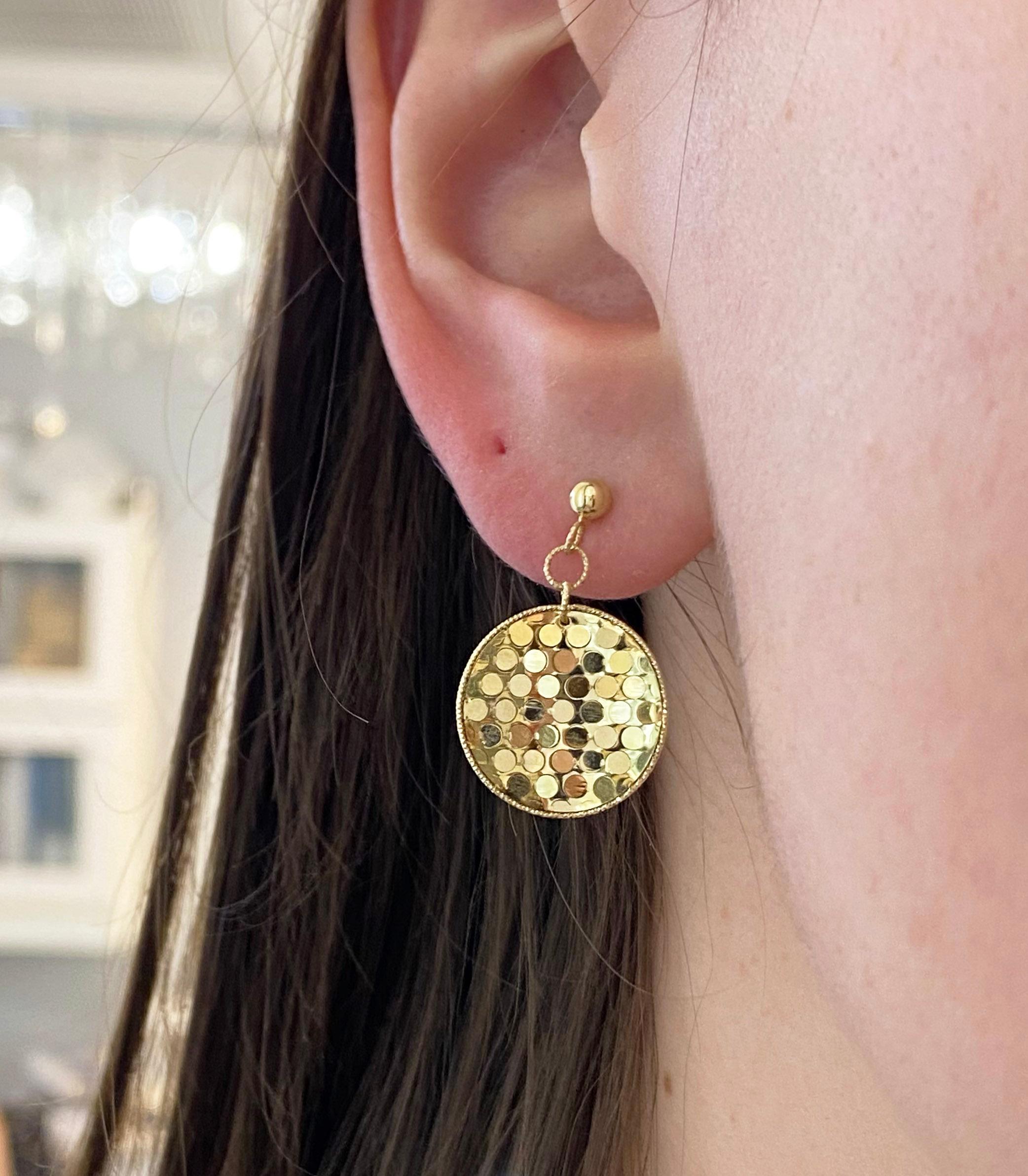 Sparkle and shine this season with our newest earring design! These solid 14 karat yellow gold earrings are designed to reflect light from every angle. The disks shimmer like gold confetti and sparkle on every ear. They are the perfect accessory to