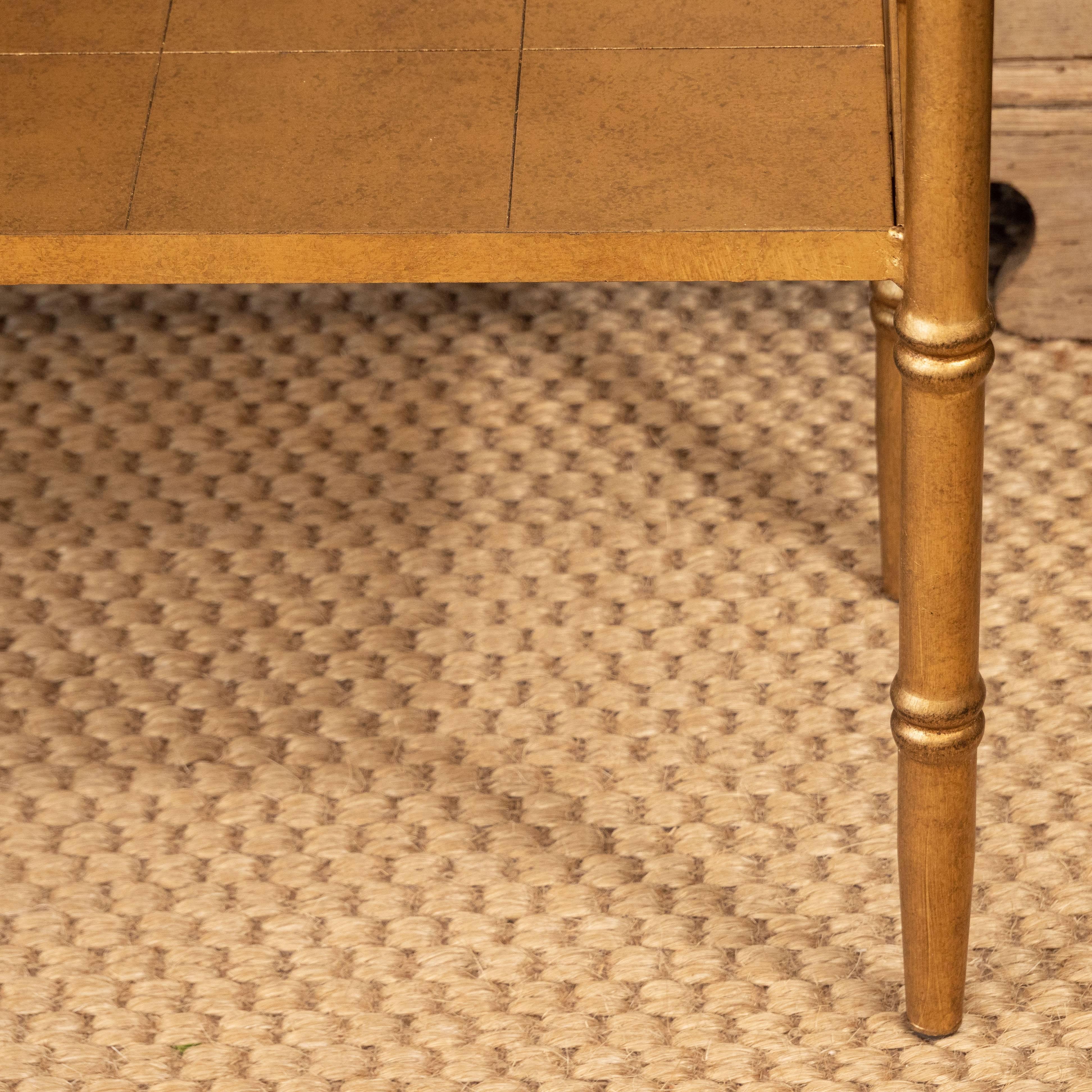 This small console table may be relatively small in size but it has big style! Constructed of wood with a gold leaf finish, the table features a molded top, a handy lower shelf and turned legs. A great layering piece for a small space.