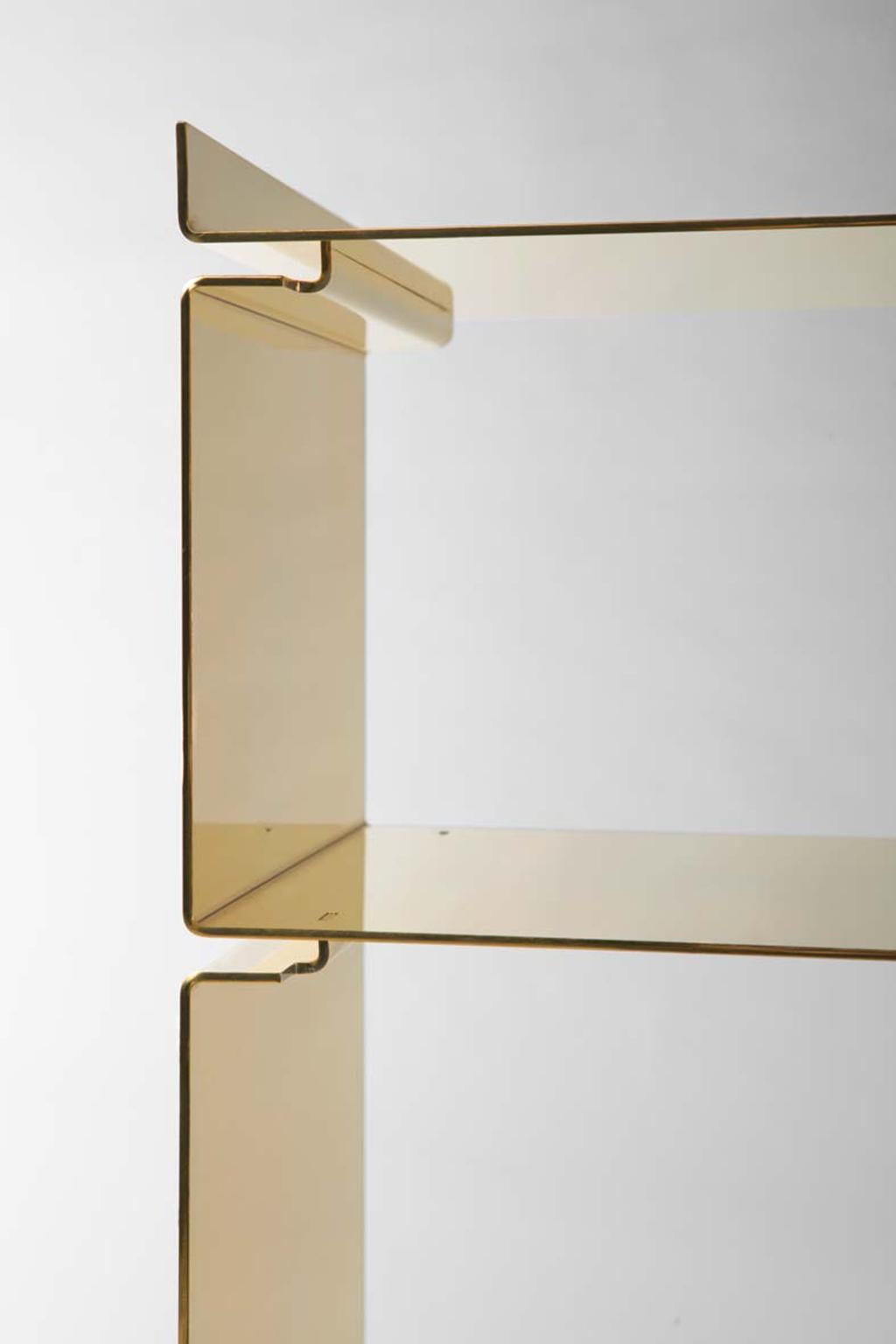 SEM Gold collection, modular bookshelf of interlocking steel elements plated in 24-karat polished yellow gold. Elements measurement: (35/30/25/18 cm).The Gold collection has a range of exemplary pieces that echo the past yet embrace the features of