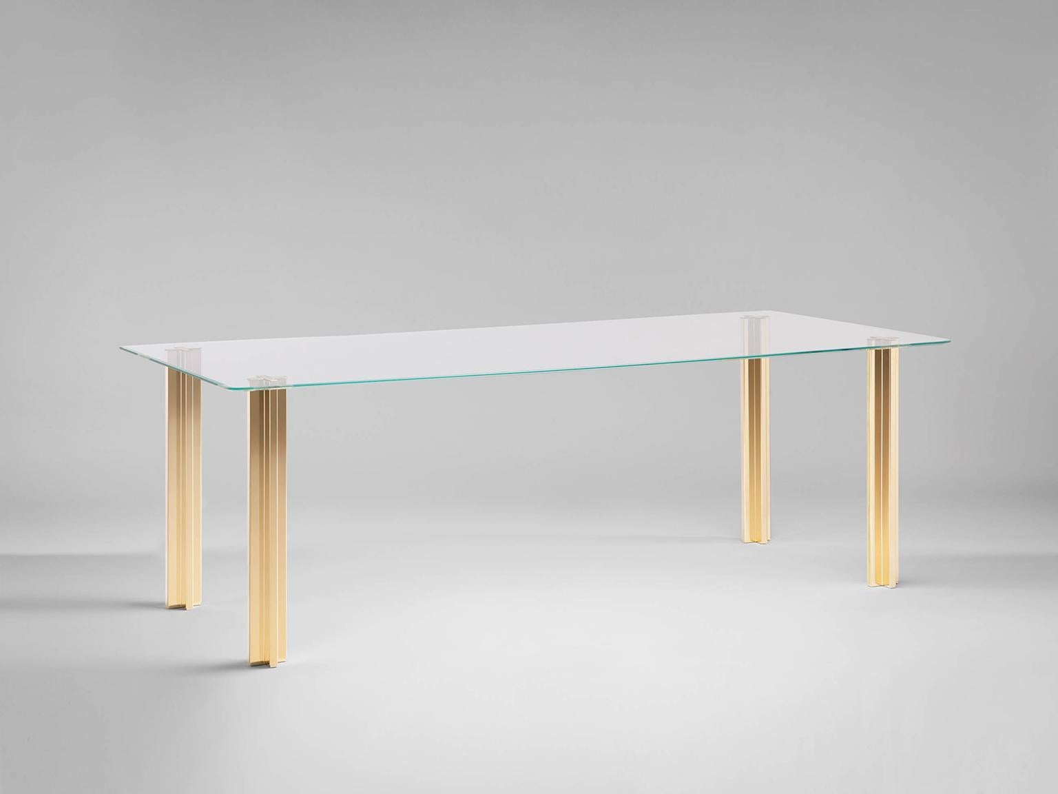 Sem gold collection, rectangular table with glass top: extra light transparent glass or smoke grey transparent glass (12 mm thick). Plated aluminium legs finished in 24-karat polished or fine brushed yellow gold. The Gold collection has a range of