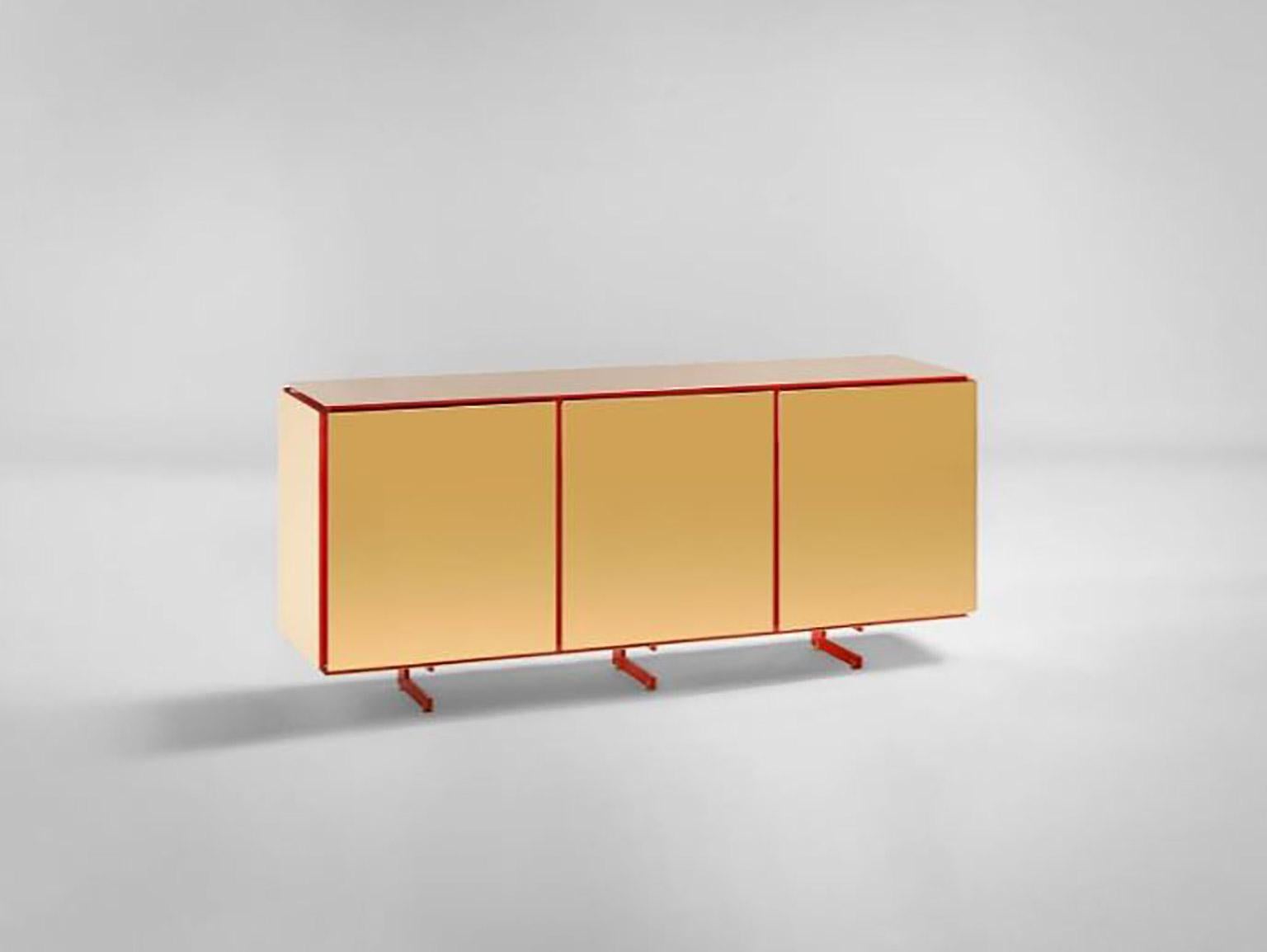 SEM Gold collection, three doors sideboard. Corallo lacquered wooden structure, gloss finish. Available more colorway variants. External shell in 24-karat polished yellow gold-plated combined with ultra-reflective steel. The Gold collection has a