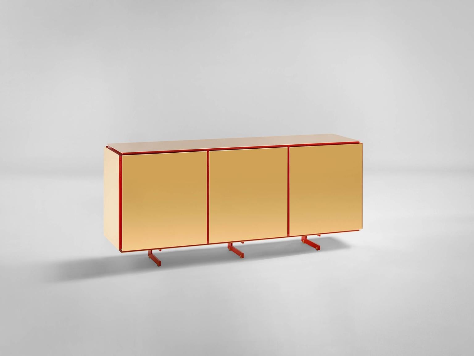 Sem Gold collection, three doors sideboard. Corallo lacquered wooden structure, gloss finish. Available more colorway variants. Plated external shell in 24-karat polished yellow gold combined with ultra-reflective steel. The Gold collection has a