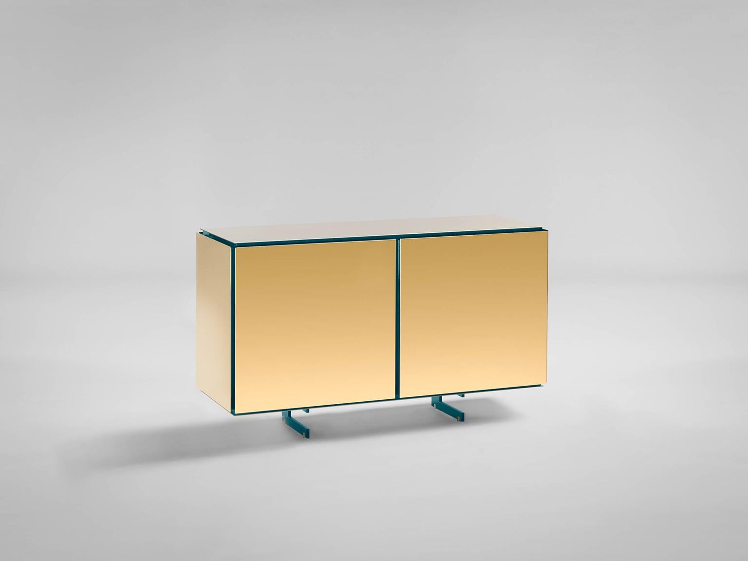 Sem Gold collection, two doors sideboard. Verdemare lacquered wooden structure, gloss finish. Available more colorway variants. External shell in 24-karat polished yellow gold plated combined with ultra-reflective steel. The Gold collection has a