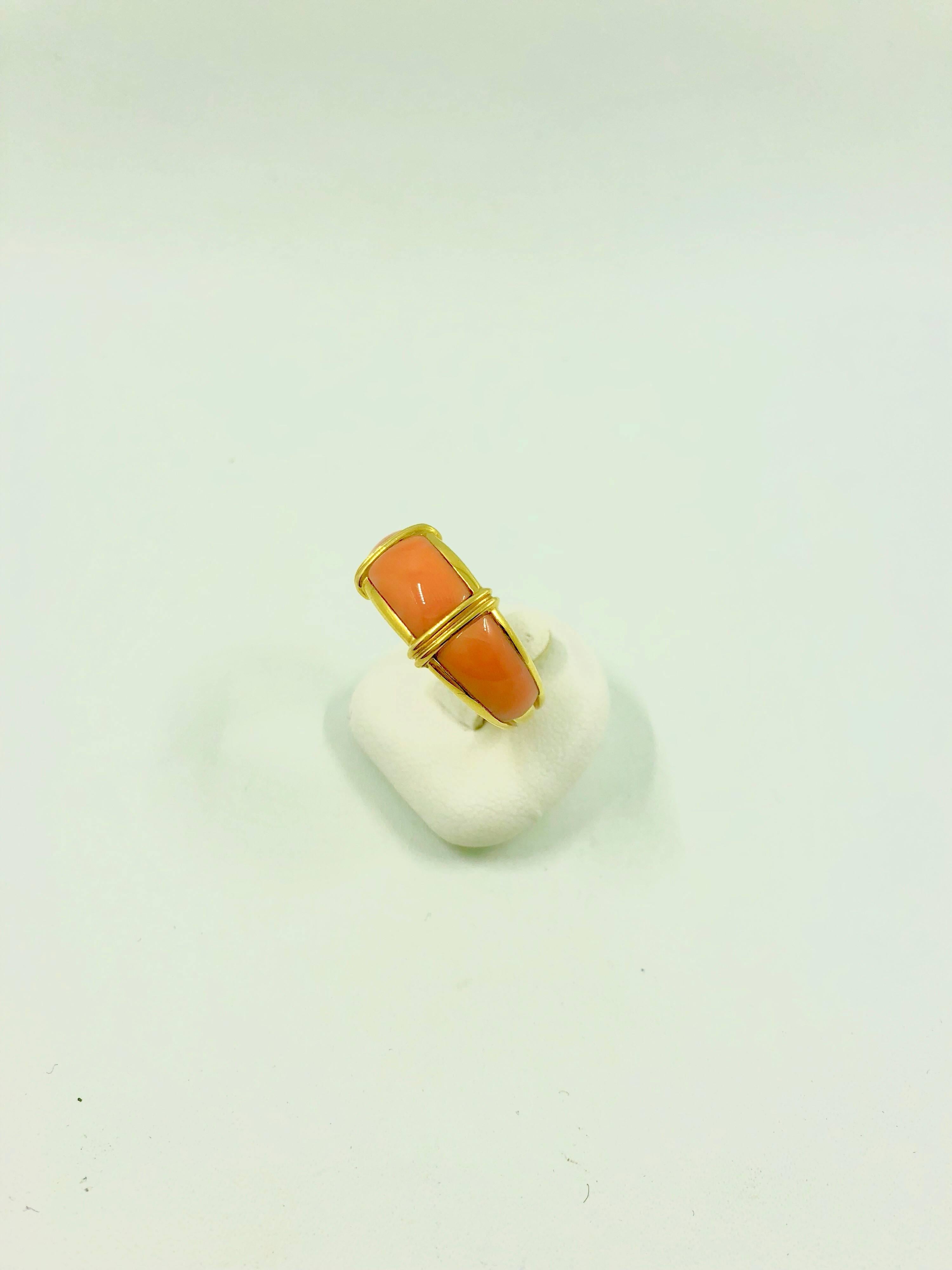 A yellow gold ring composed with three rectangular cabochon coral spaced with fine yellow gold bars.
Net Weight: 6.80 grams 
Finger Size: 6.5 (can be sized)