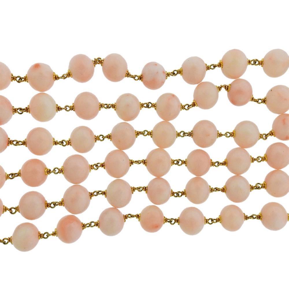 18k yellow gold 5 row coral bead bracelet. Corals are approx. 9.5-10mm, pearls on the clasp. Bracelet is 7.5