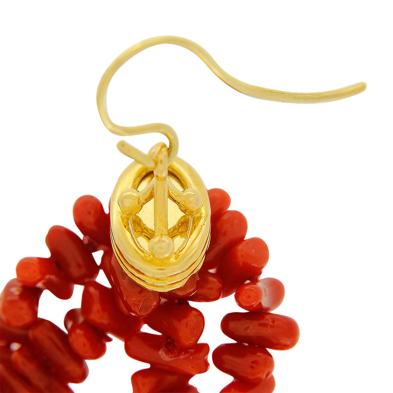 This unique pair of earrings features 18kt yellow gold signature Crown Cap with 4 strands of Sardinian Coral tassels and french hook. 