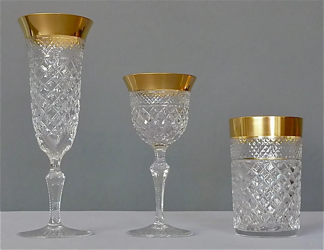 Gorgeous 20th century handcrafted faceted crystal glass set with 24 carat gold rim made by Josephinenhütte Moser around 1960-70 and very is the style of the exclusive french company Baccarat or Saint Louis thistle. This set of 24 pieces comprises