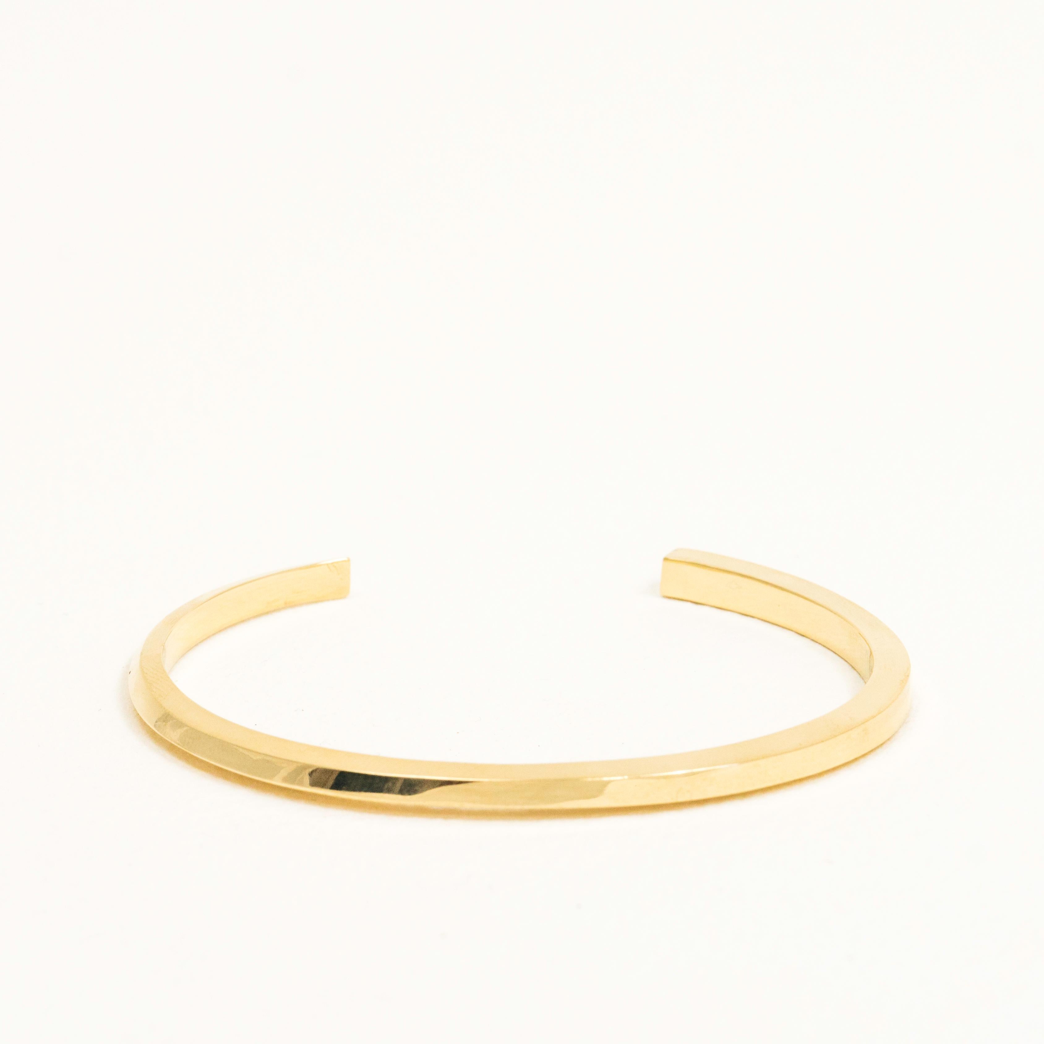 The Flow Cuff Bracelet in solid 14k gold begins as a triangle and evolves into a square at its opposite end. This elegant bracelet can blend seamlessly into any style or become a brilliant minimalist statement piece on its own. The cuff bracelet is