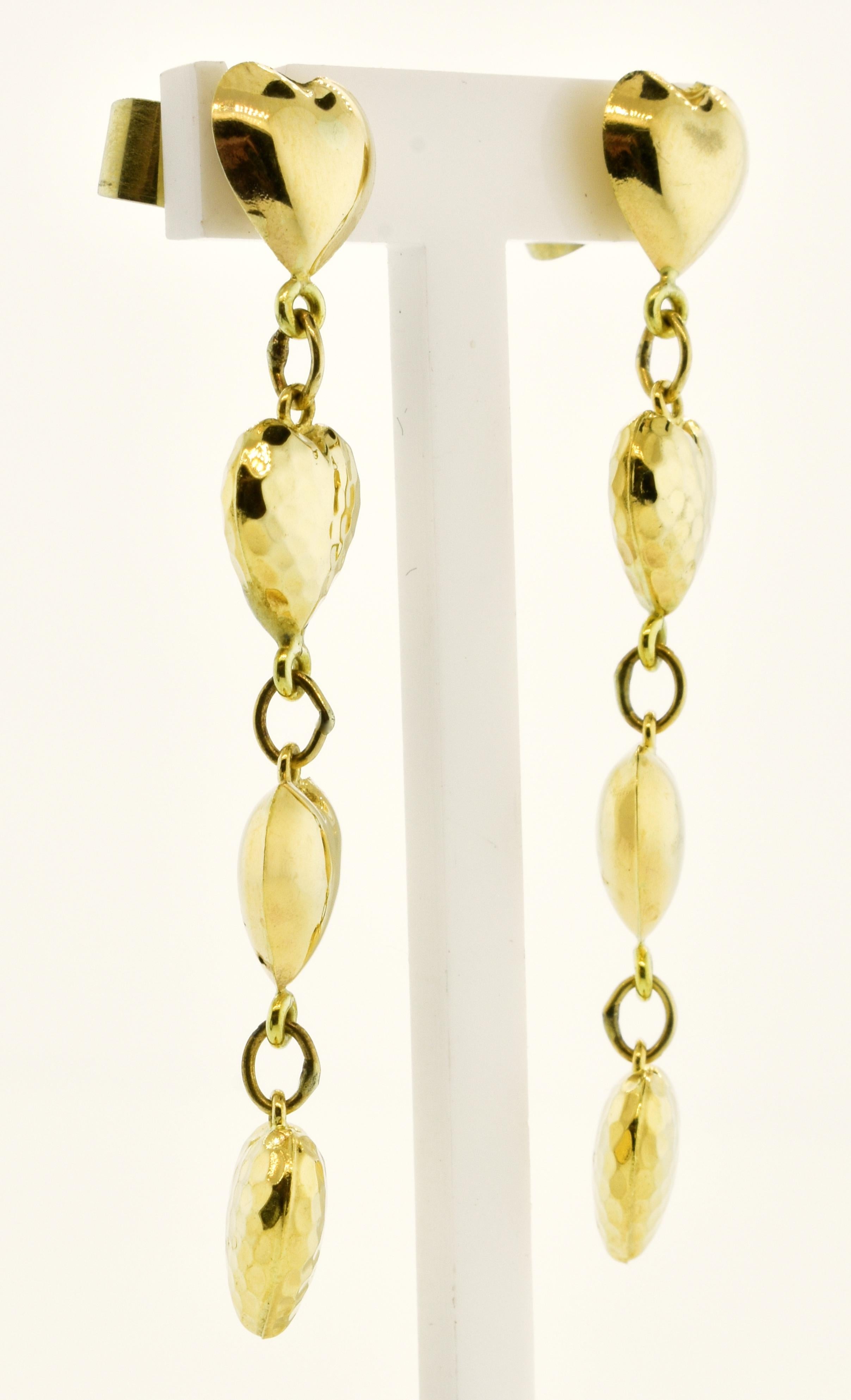 Gold dangling earrings in heart motifs, these earrings  are comprised of smooth and faceted gold hearts.  They are in fine condition and easy to wear.  They weigh 4.44 grams and so are easy to wear but have a nice strong gold look.  If you love to