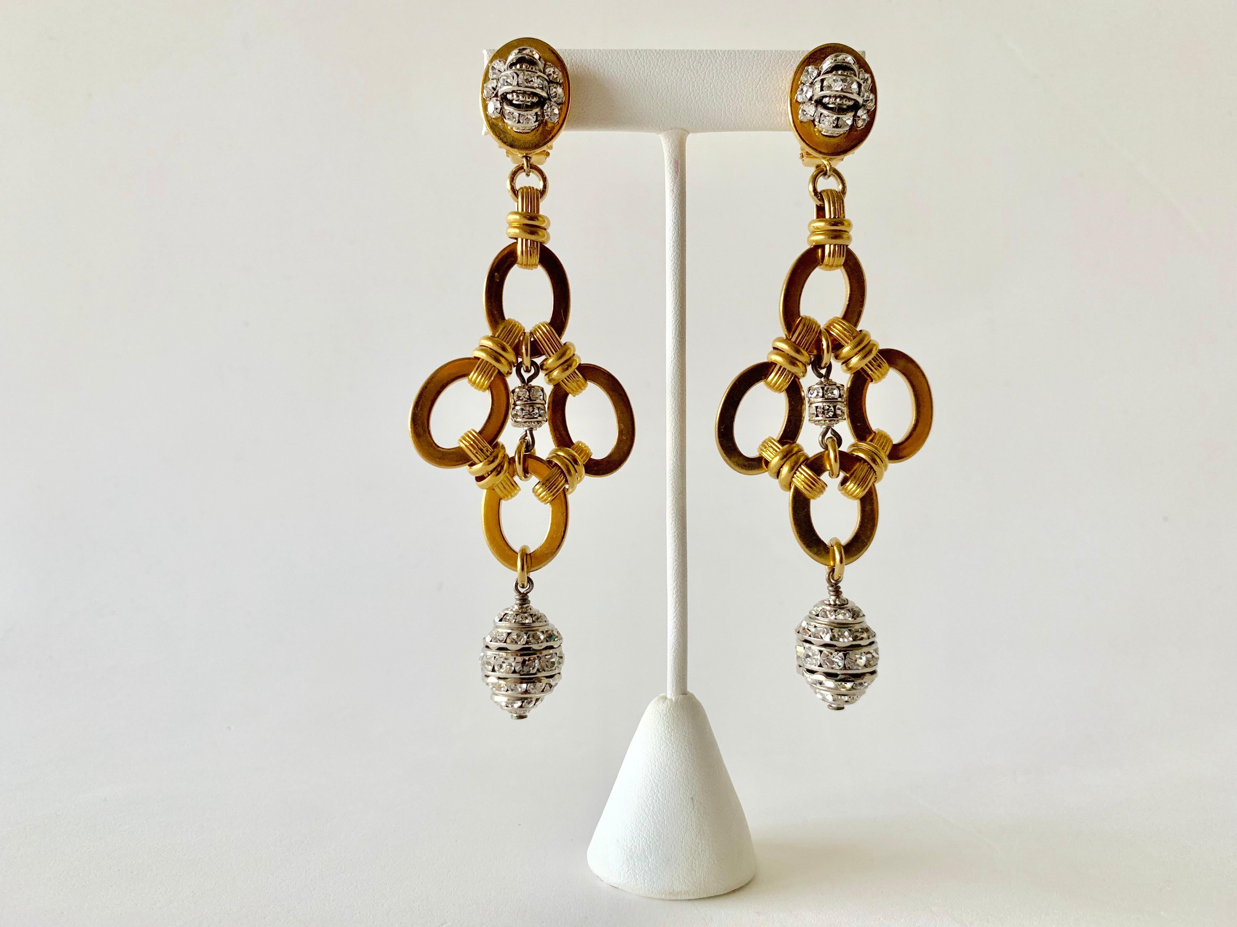 Contemporary gold diamante chandelier statement earrings made in France - the statement earrings are comprised out of oval gold-tone links and are adorned by silver diamante rondels. 