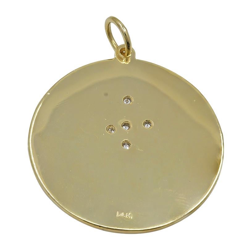 Large round charm.  14k yellow gold.   Engine-turned background, with two applied champagne goblets and eight star-shaped bubbles, five set with diamonds.  Applied letters spell out 