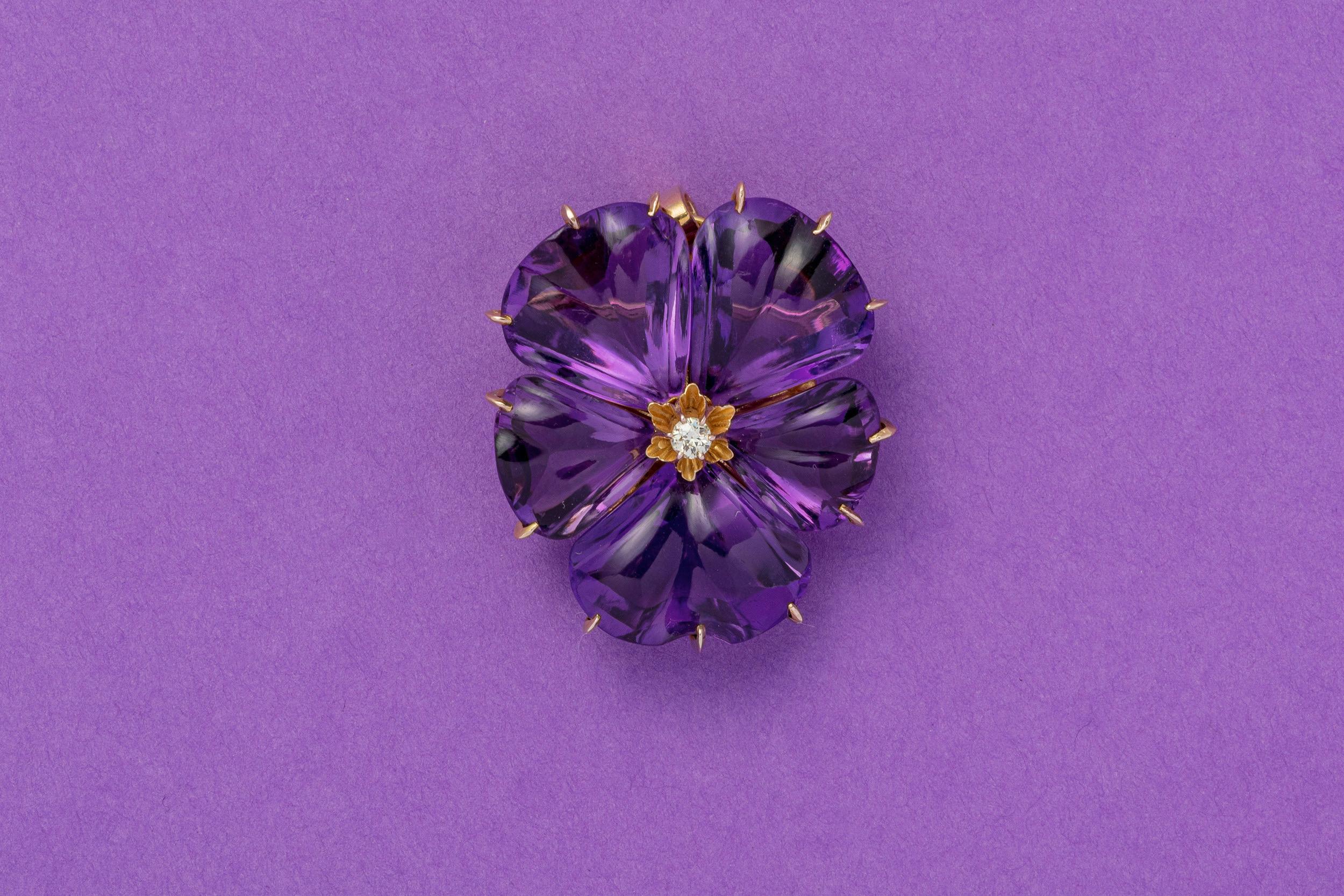 An 18 carat gold love token of a large pansy with carved amethyst leaves and a diamond at the heart of the flower. The word pansy derives from the French word “penseé”  which means “thought”, when you gift someone this pendant they will know that