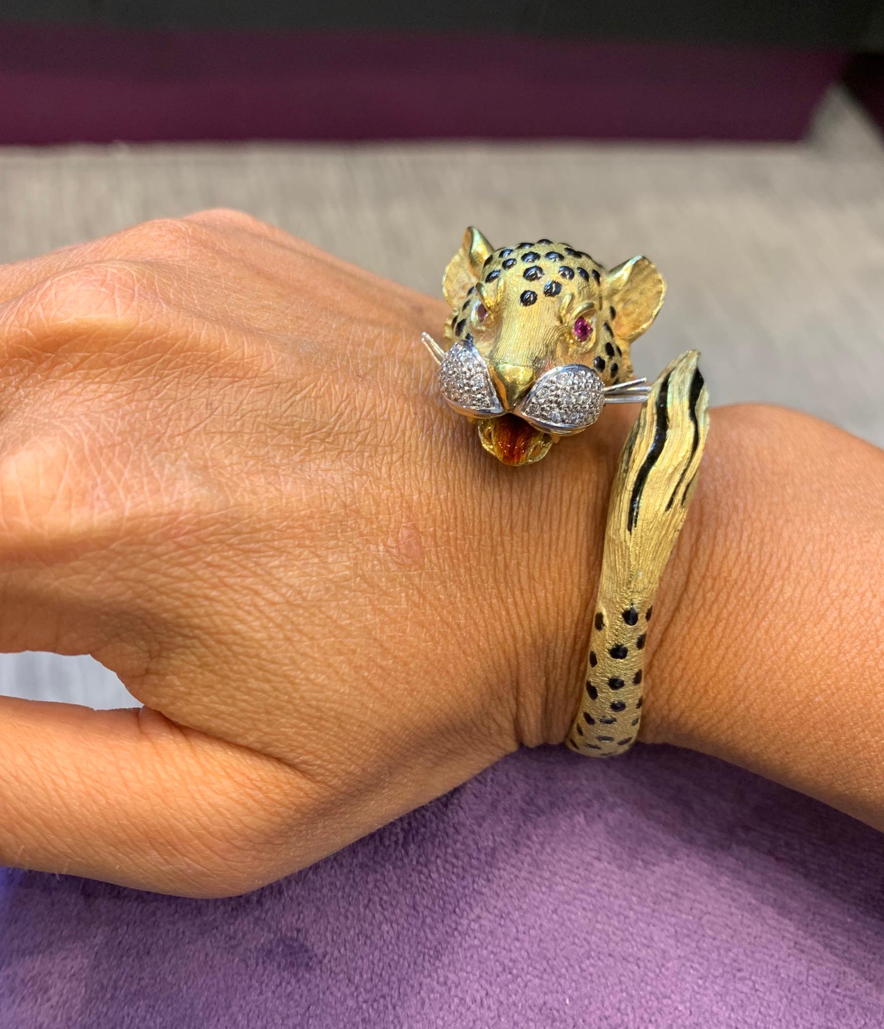 Gold And Diamond Enamel Leopard Bangle Bracelet with Ruby Eyes 

18Karat gold:
Inner circumference: 2.5”
Gram weight: 71.8 Grams 
