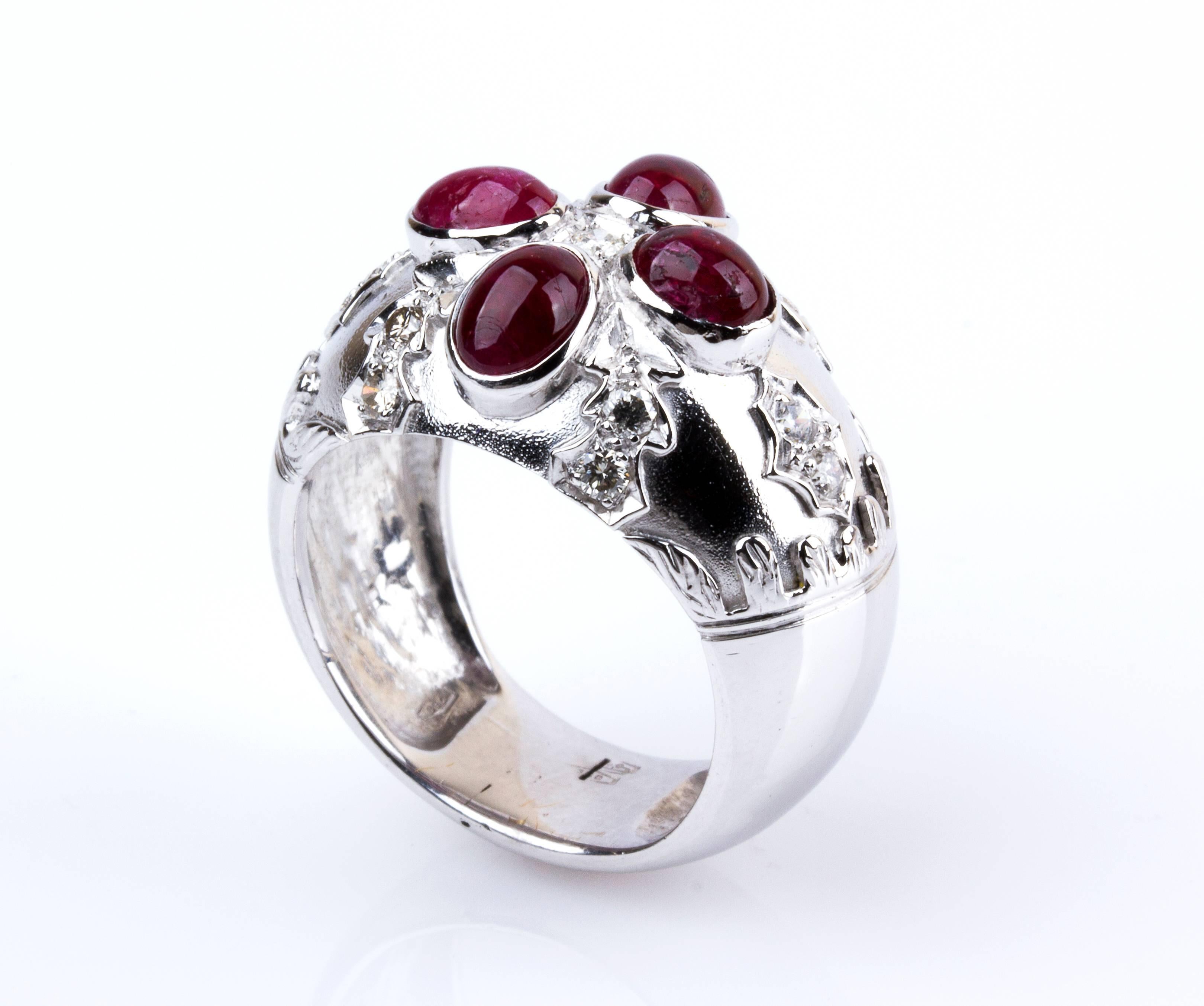Shaped as a band set 4 cabochon-cut rubies and 13 round brilliant-cut diamonds decorated by floreal motifs. Size US 9. Weight 17.70 gr. Italian assay mark 750. Item condition grading: **** good.