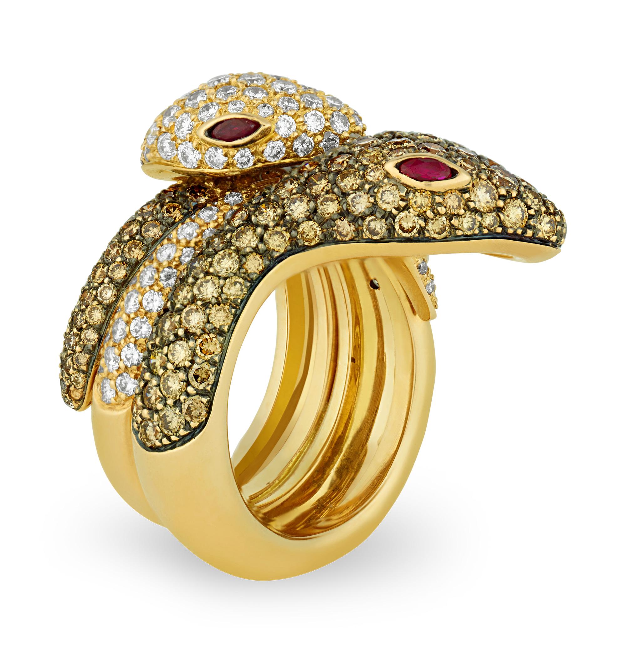 Slithering with sophistication, this unique piece intertwines two snakes into an elegant ring. Crafted of lustrous 18K gold, one snake is set with sparkling white diamonds while the other is set with exquisite champagne diamonds. Each serpent is