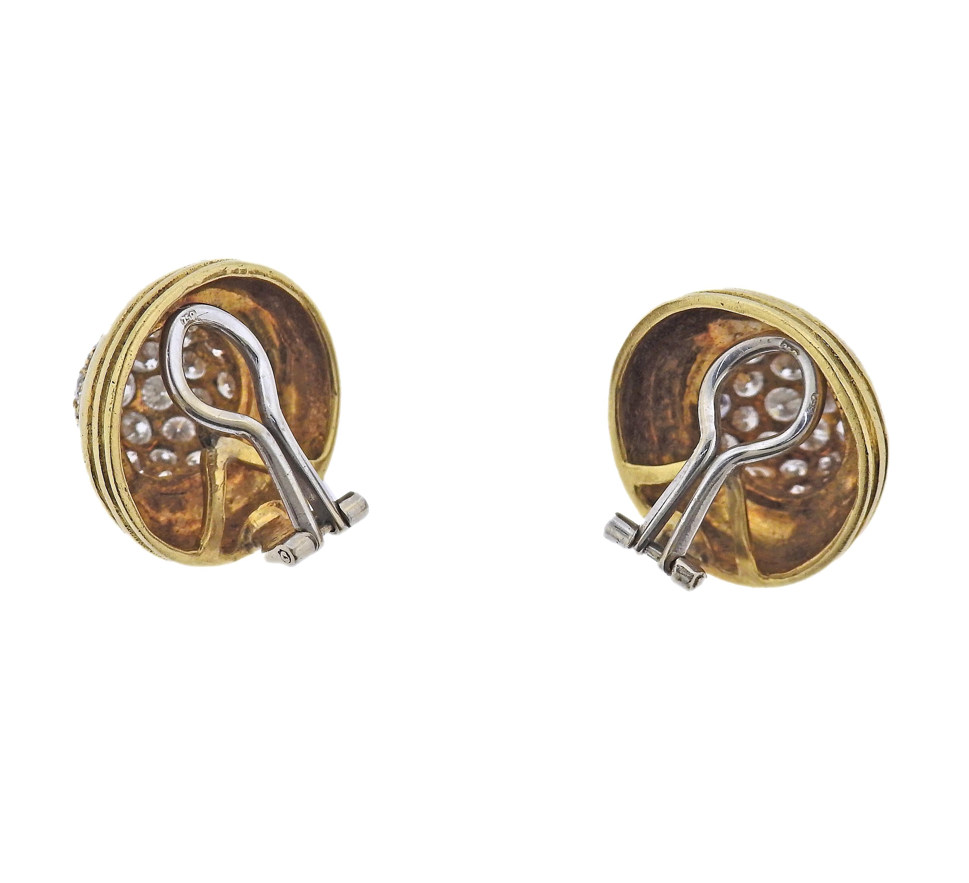 Pair of 18k gold button earrings, set with approx. 1.20ctw in H-I/Si diamonds. Earrings measure 19mm in diameter. Marked 18k. Weight - 13.4 grams.