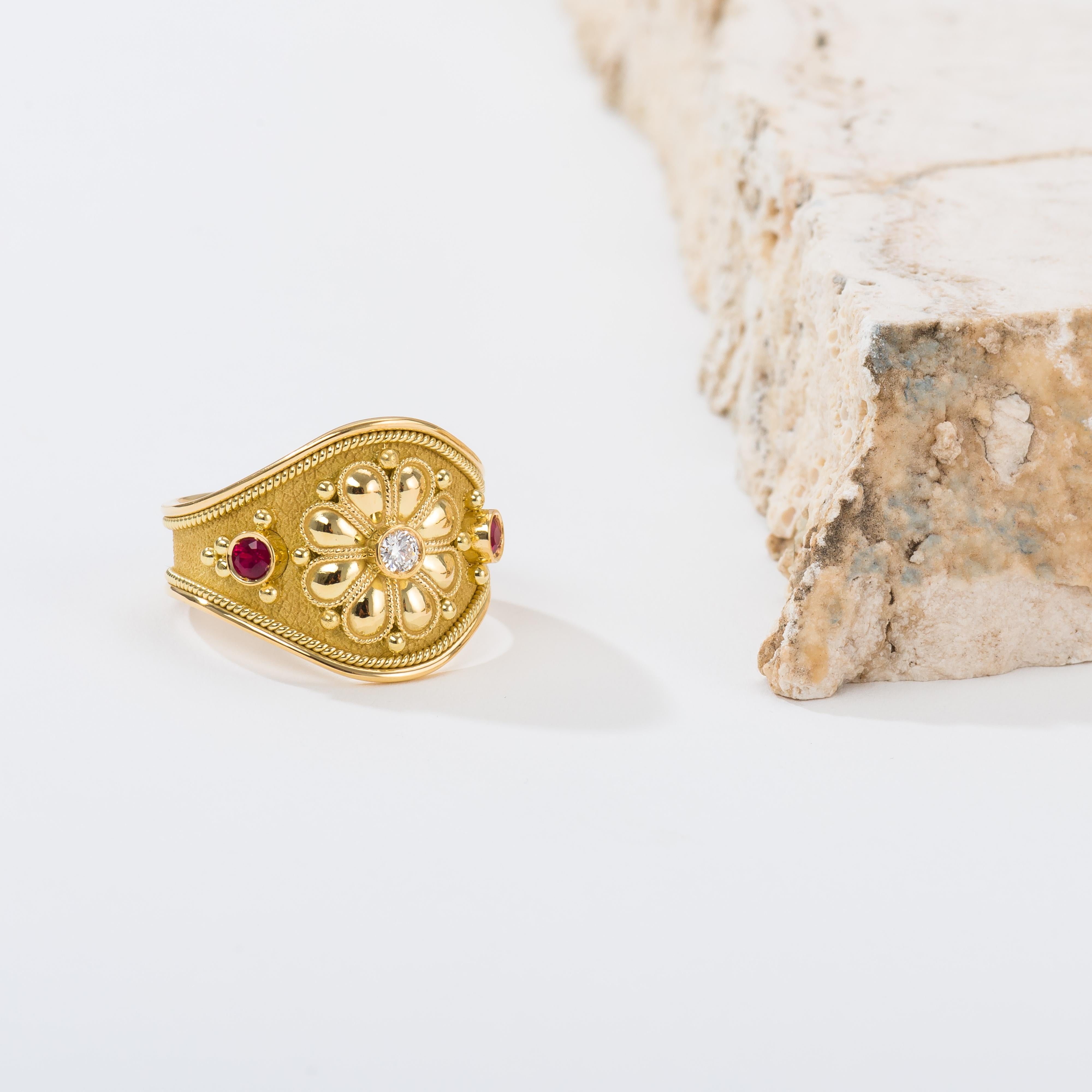A luminous gold shiny daisy, adorned with a radiant diamond center, and embraced by two vibrant rubies, makes this gold ring a masterpiece of elegance and natural beauty, a daily reminder of enduring grace and timeless allure.

100% handmade in our