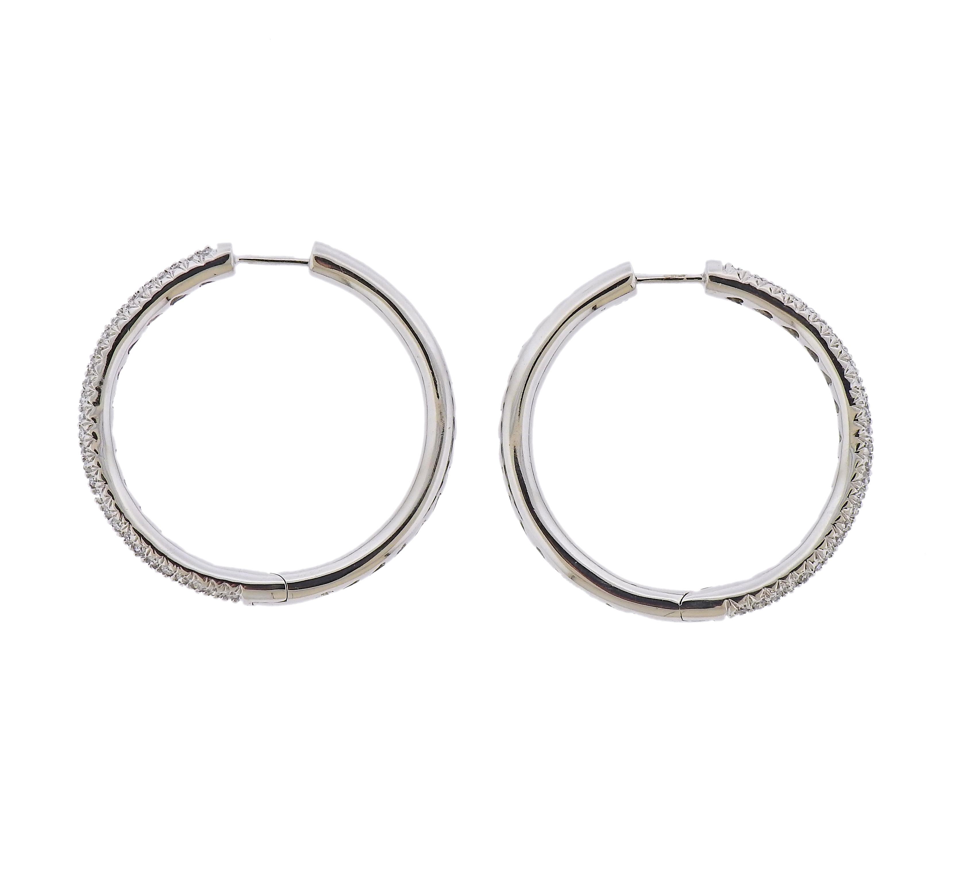  Pair of 18k white gold classic hoop earrings, set with approx. 1.00ctw in diamonds. Earrings are 30mm in diameter x 3mm wide. Marked: 750. Weight - 10.3 grams.