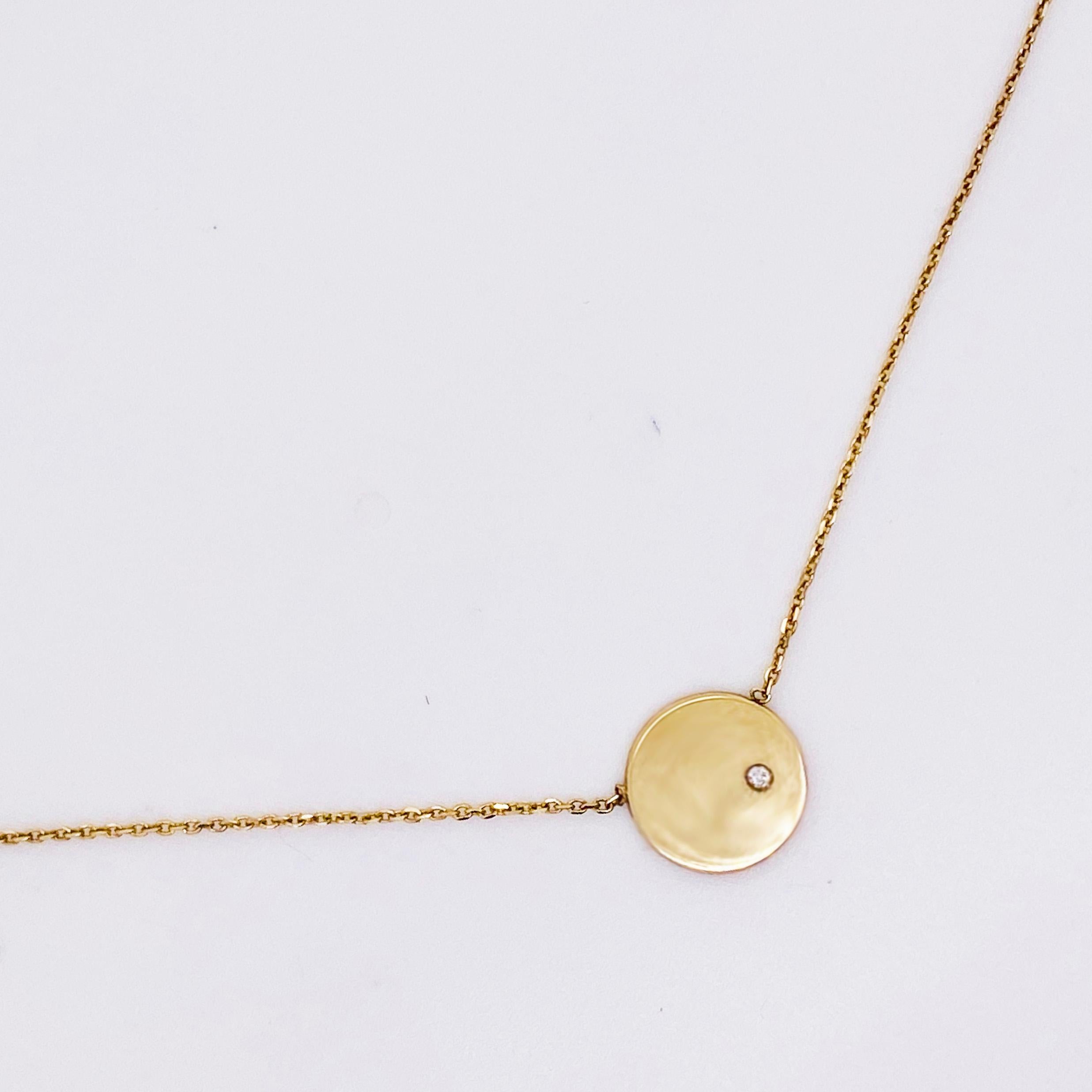 This 14K Yellow Gold Disk has a genuine, natural diamond set off-center.  The disk is about 1/2 the size of a dime and The chain is an adjustable solid 14 karat yellow gold.  The 14 karat yellow gold cable chain is 16 to 18 inches long and has the