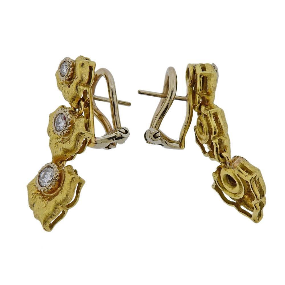 18k gold earrings with diamonds approx. 0.70ctw. Measures -30mm x 11mm. Weights 13.1 grams. Tested 18k gold.
