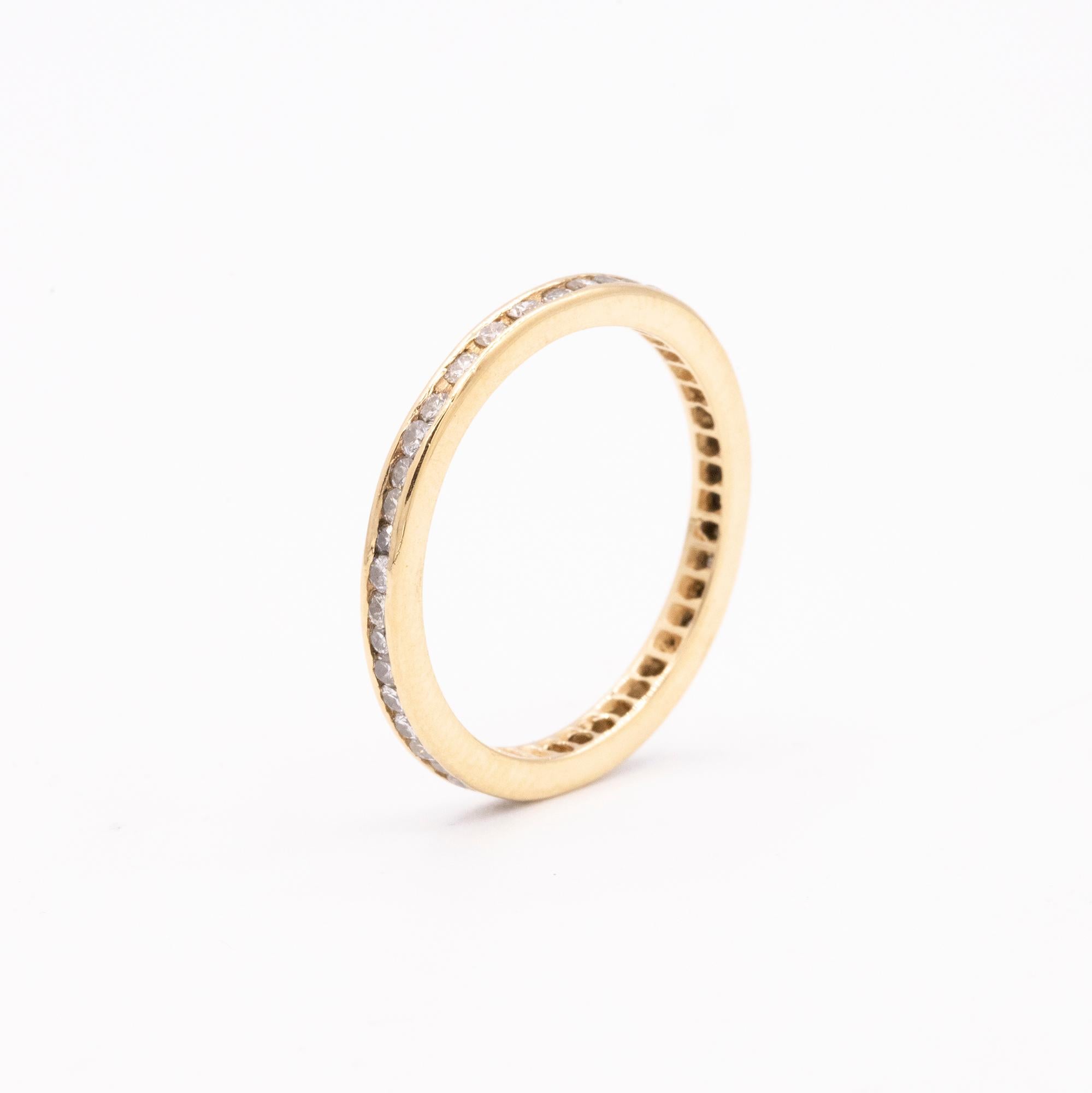 Vintage 14kt Yellow Gold Diamond Eternity Band. 2mm in width. The band has 40 channel set round brilliant diamonds.