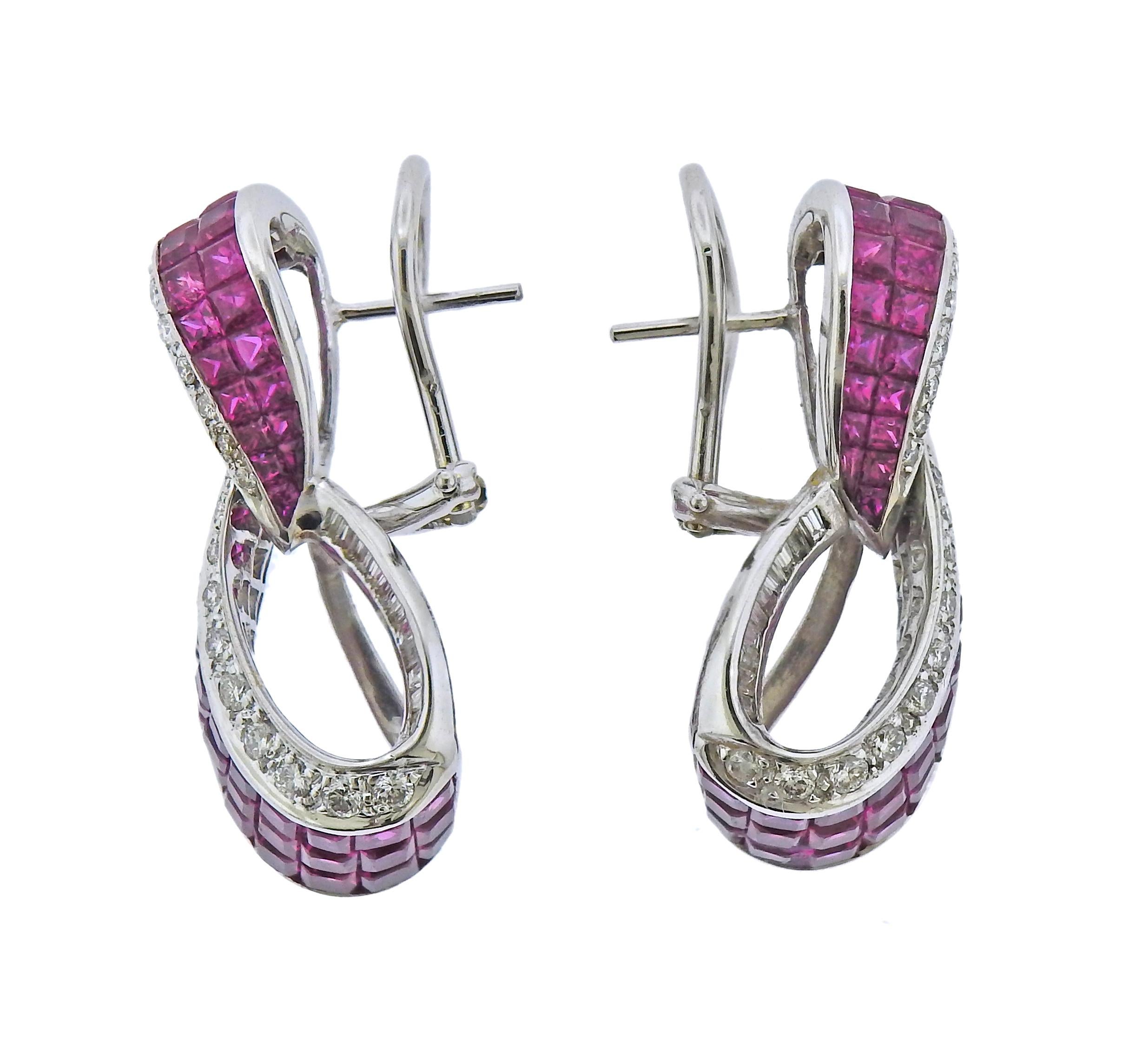 Pair of 18k white gold cocktail earrings, with invisible set rubies and approx. 060ctw in H/VS-SI1 diamonds. Earrings are 35mm x 15mm. Weight - 18.2 grams.