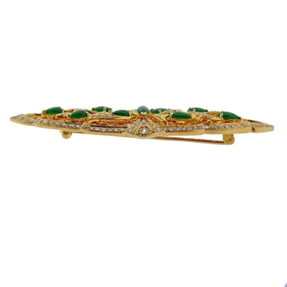 18k yellow gold brooch, set with 10 jade gemstones and approx. 1.70ctw in diamonds. Brooch measures 80mm x 30mm. Marked DIF 750. Weighs 18.6 grams.