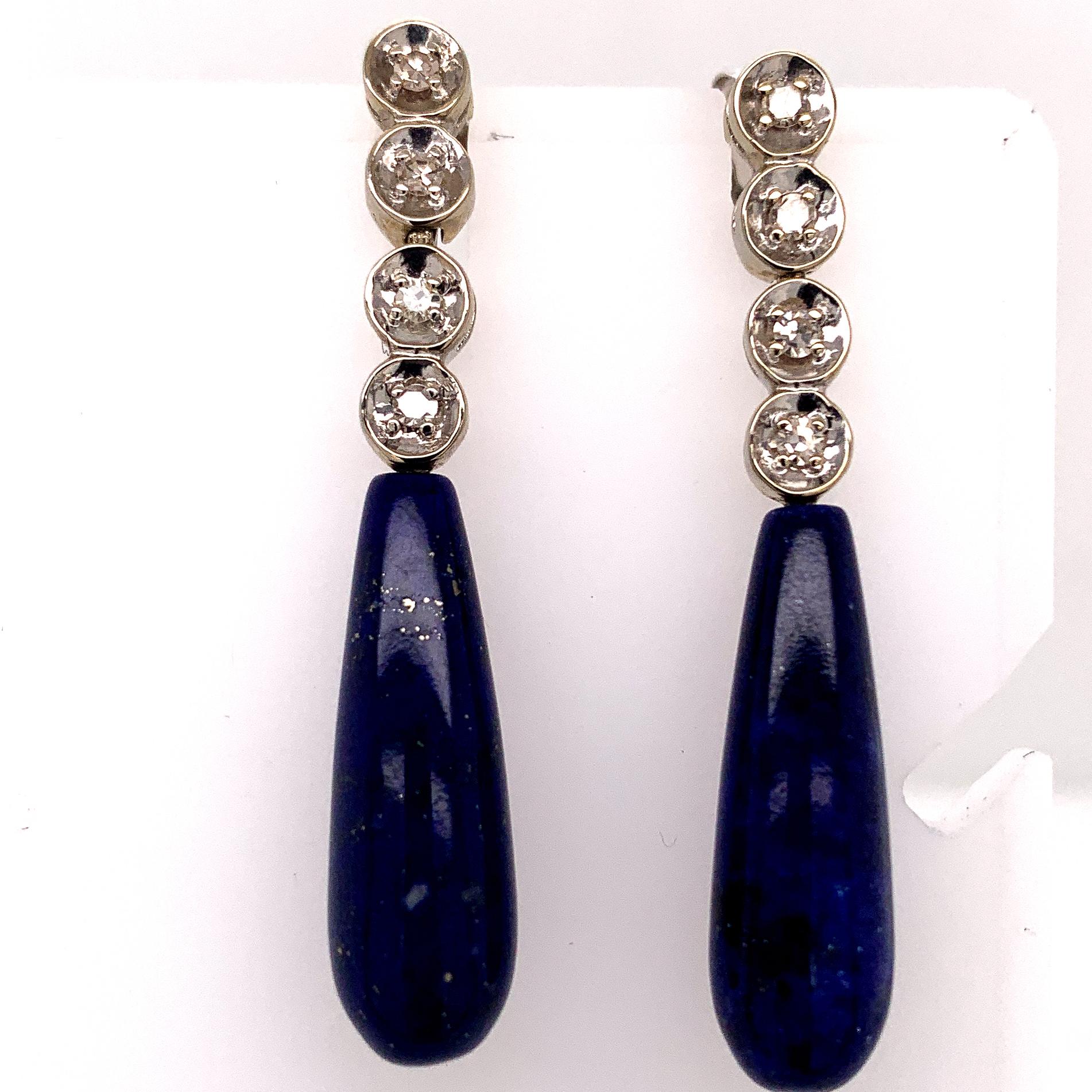 Striking lapis and diamond drop earrings.  Suspended from four bezel-set brilliant diamonds.  Set in 14K yellow gold.  1 1/2