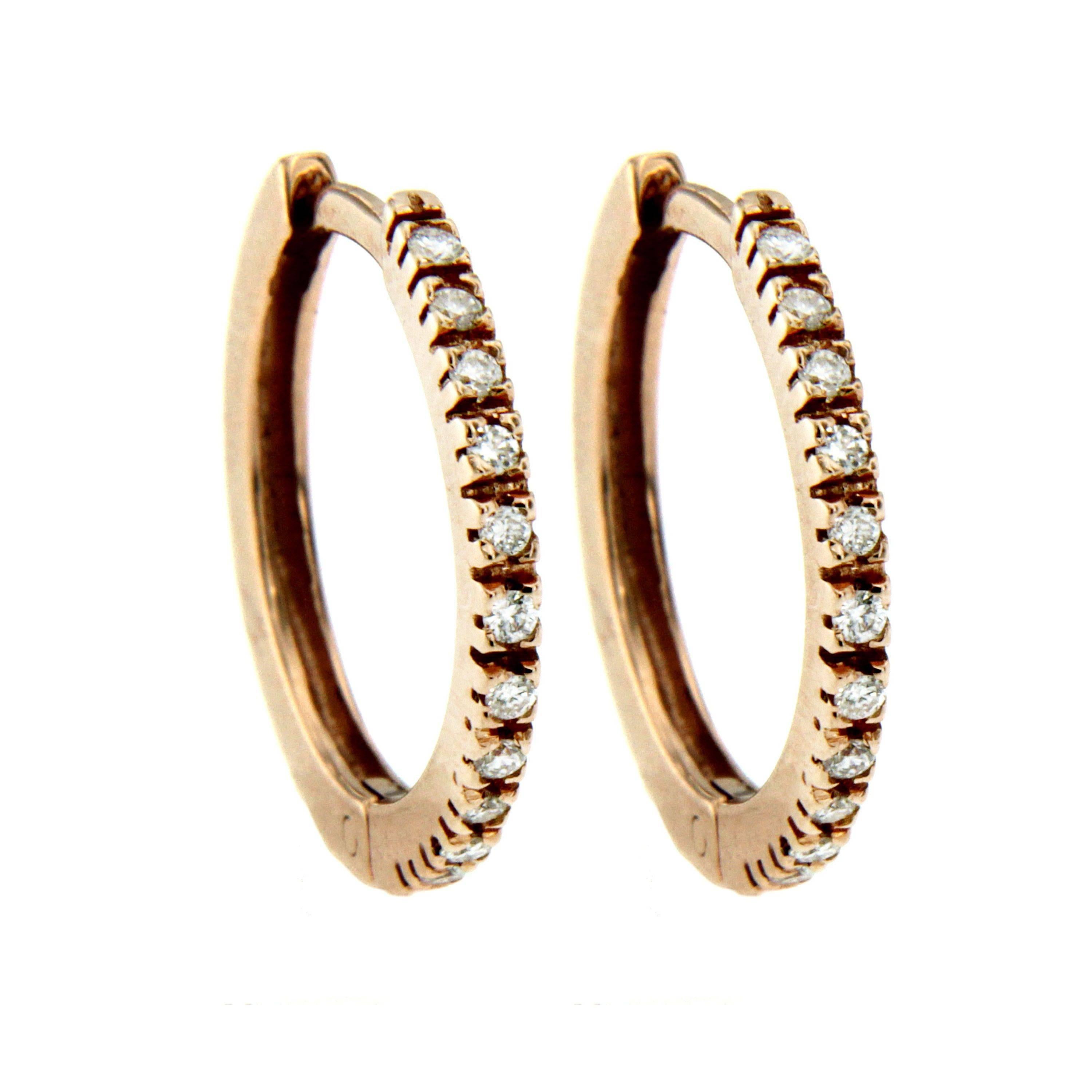 These hoop earrings are crafted in Italy from 18k rose gold and embellished with 0.15-carats of sparkling Round brilliant cut Diamonds, graded G color Vvs clarity. The delicate size makes them perfect for every day.

These earrings are from our own