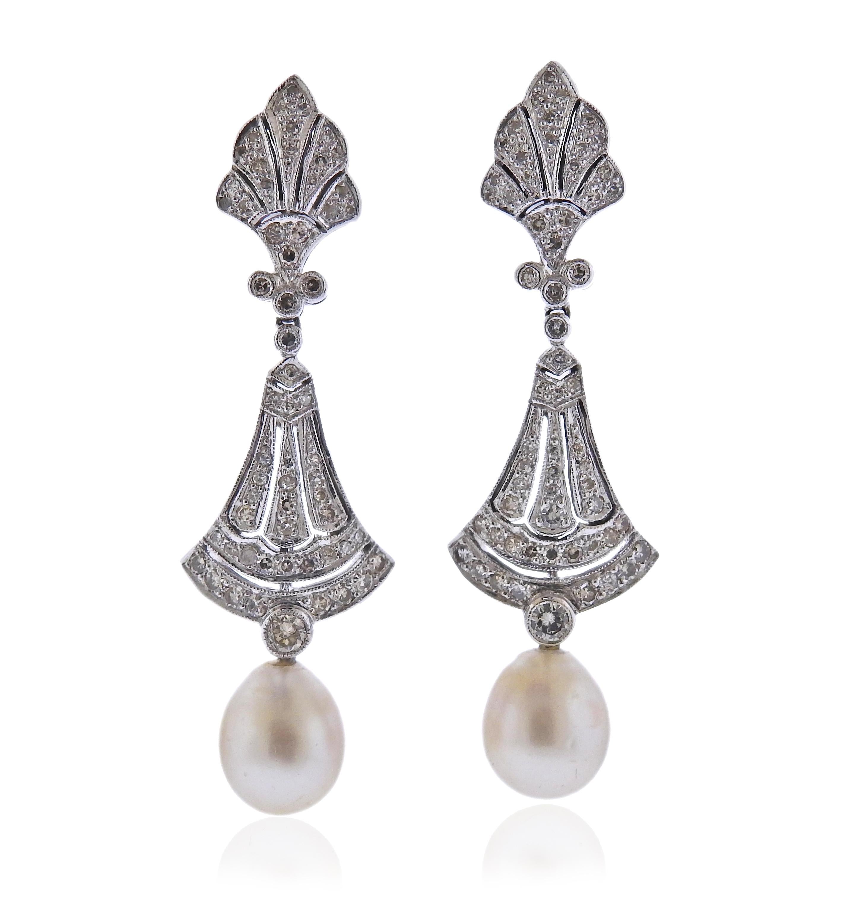 Pair of 18k white gold earrings with pearls and approx. 0.66ctw  in SI/H diamonds.  Earrings are 50mm long, pearls are detachable. Weight 11.5 grams.
