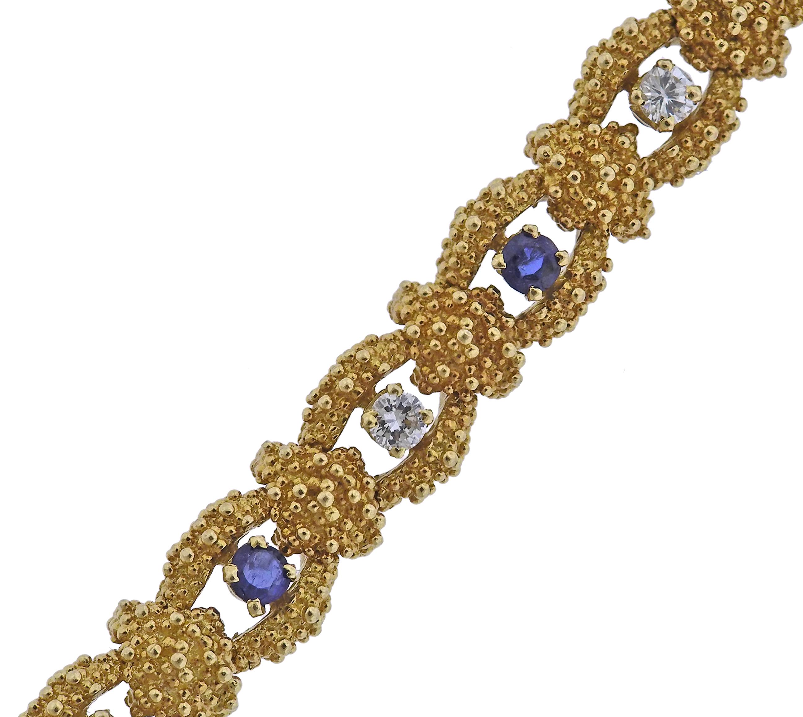 18k textured gold bracelet, with blue sapphires and approx. 0.80ctw in diamonds. Bracelet is 7