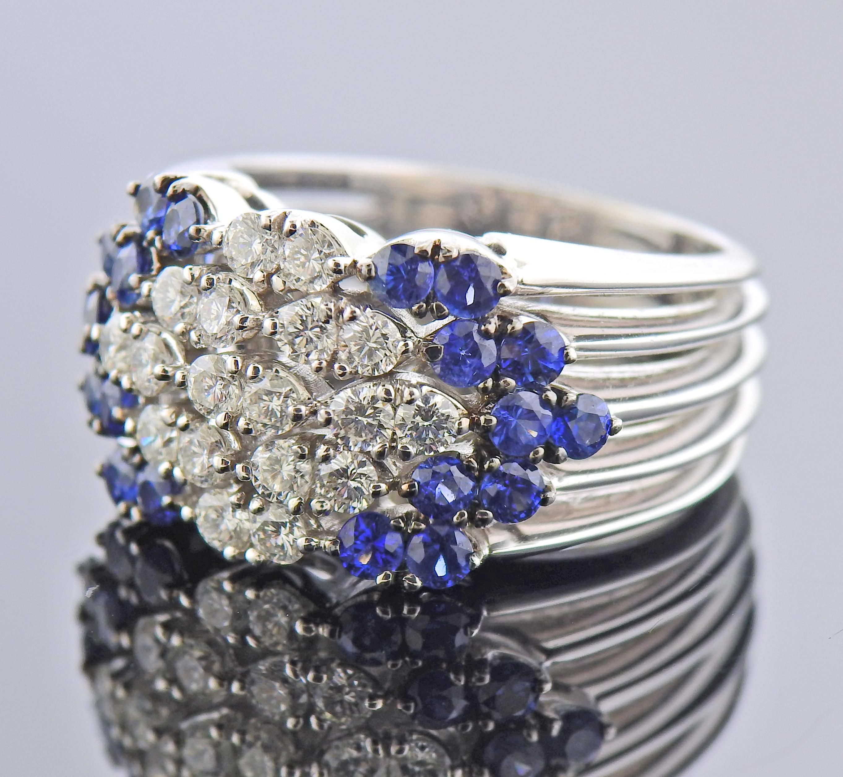 18k white gold ring, with blue sapphires and approx. 0.90ctw in diamonds. Ring size - 6.5, ring top is 14mm wide. Marked: 750, Italian mark. Weight - 14.4 grams. 