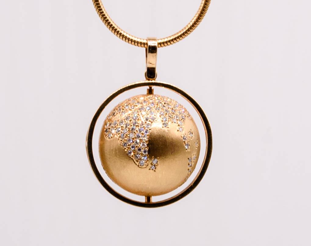Charm jewels hit a unique spot in the heart of the jewelry wearer; highly personal, memorable, indicative of decades and styles past. This delightful little object is a spinning globe fashioned in 14 karat gold, all the continents pavé set with tiny