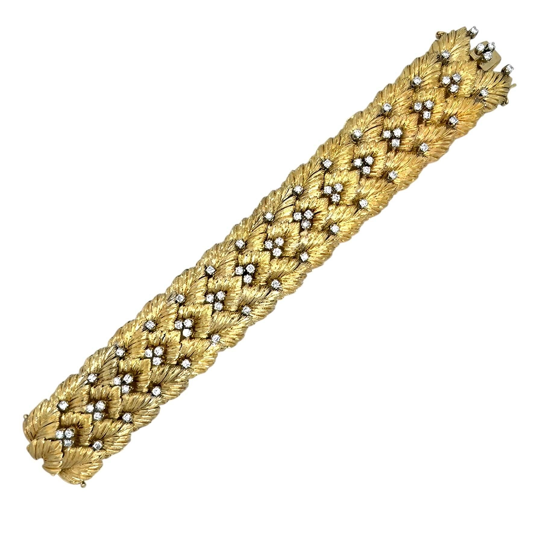An 18 karat yellow and white gold and diamond bracelet.  The yellow gold bracelet fashioned as three overlapping rows of textured leaves decorated with 30 individually set and 15 triads of brilliant cut diamonds in white gold.  Total diamond weight