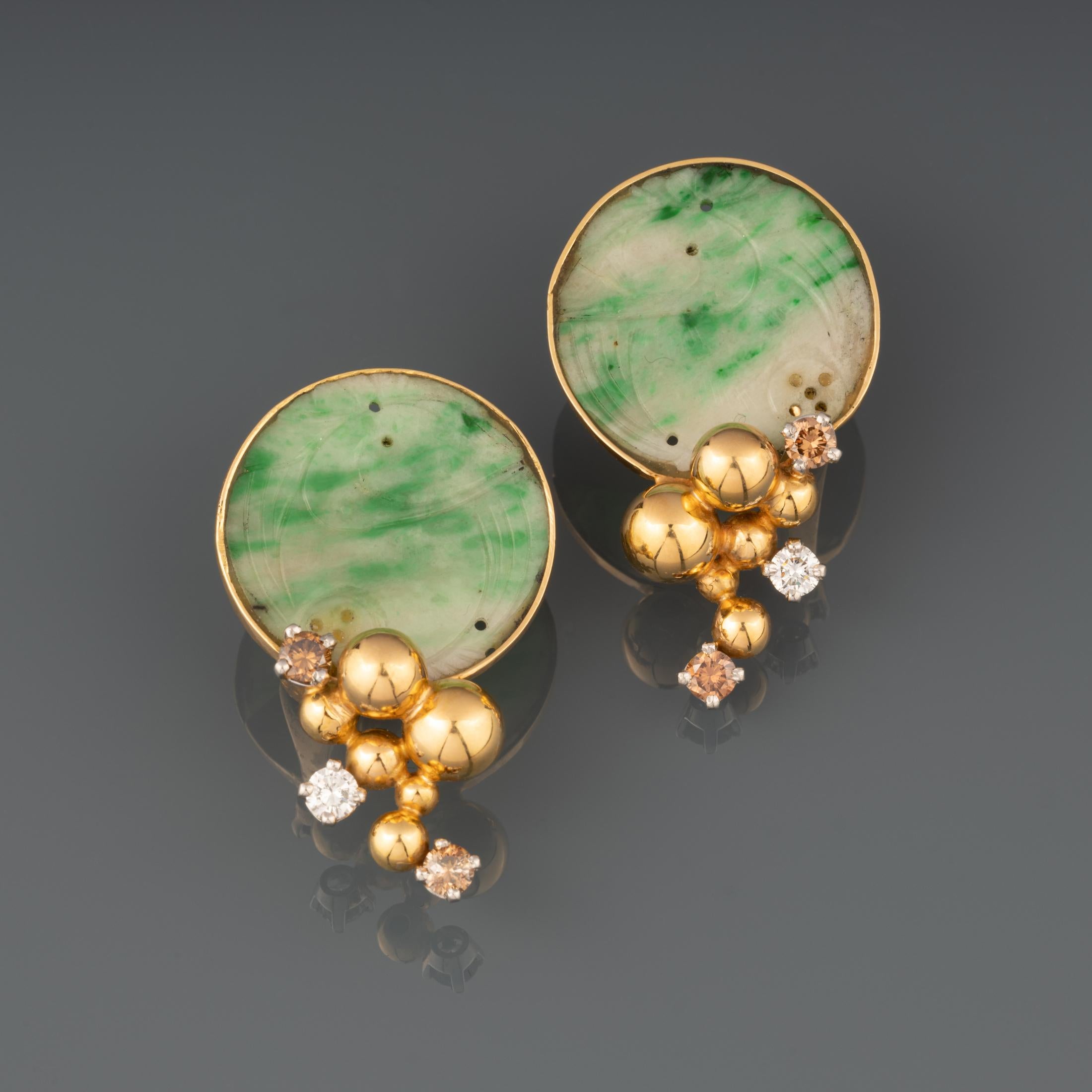 A beautiful vintage pair of earrings, made by great French creator Jean Vendome.

Made in yellow gold 18k and set with diamonds and two handgrave Jades Jadeite.

37 mm height, the jade diameter is 22mm.

Weight: 13.50 grams

Signed