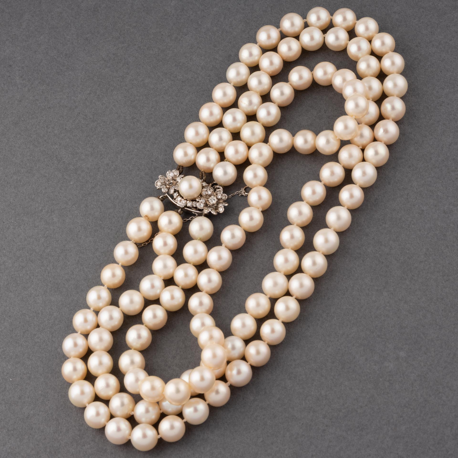 A very lovely necklace, made circa 1960. 
Made in white gold 18k for the clasp. Set with three rows of Akoya pearls. The dimension of clasp is 32*15mm.
The pearls diameter is 10mm.
