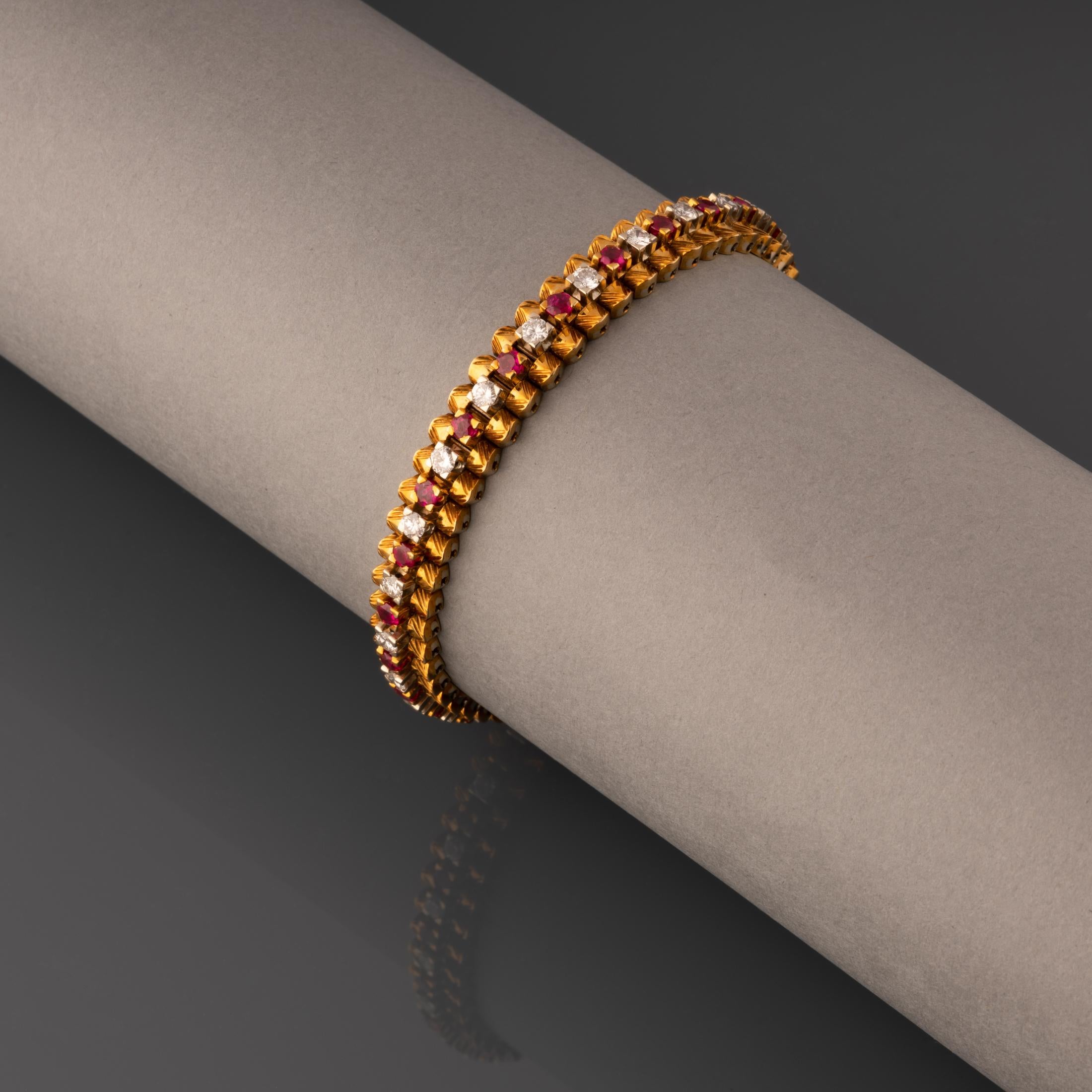 A very lovely retro bracelet, European made circa 1960.

Made in yellow gold 18K and set with diamonds (2.50 carats approximately) and rubies(2.50 carats approx).

Length: 18cm

Width: 8mm

Weight: 41.30 grams